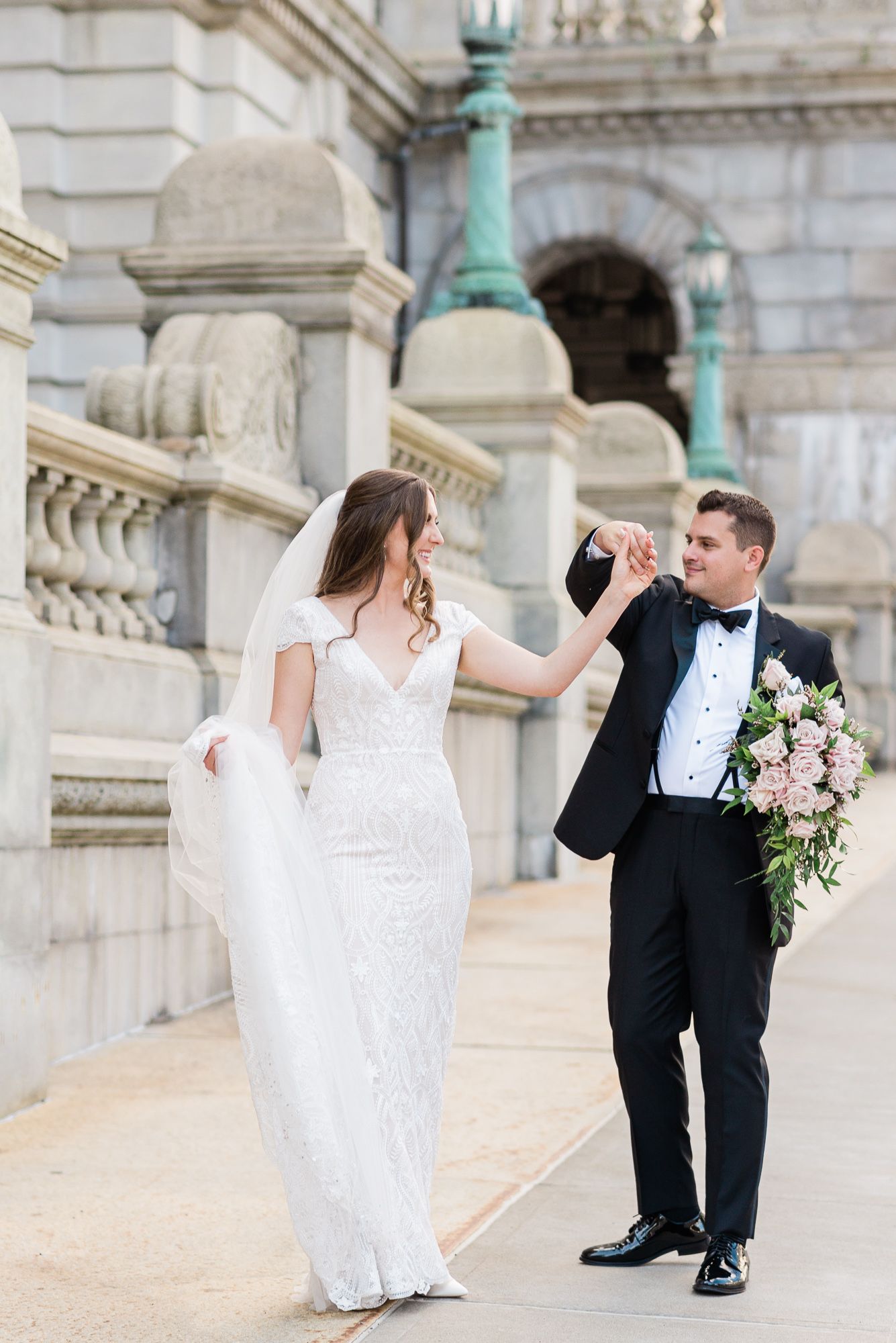 A bride and groom dance together during their first look ceremony.