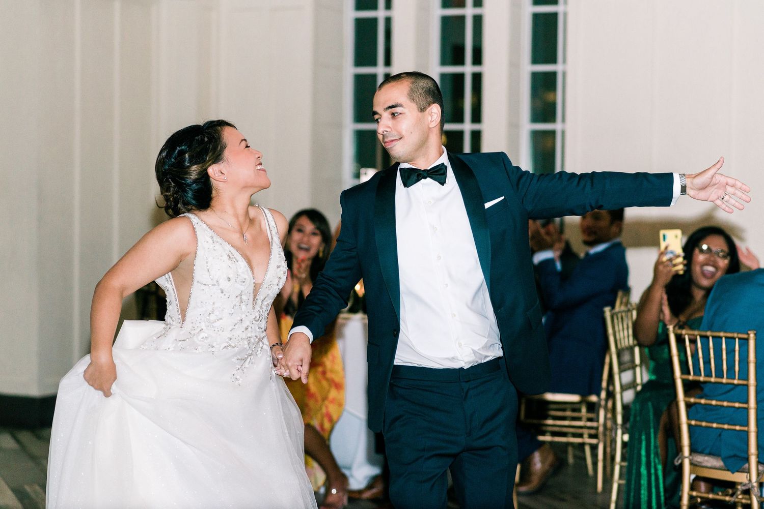a bride and groom dance for their wedding entrance