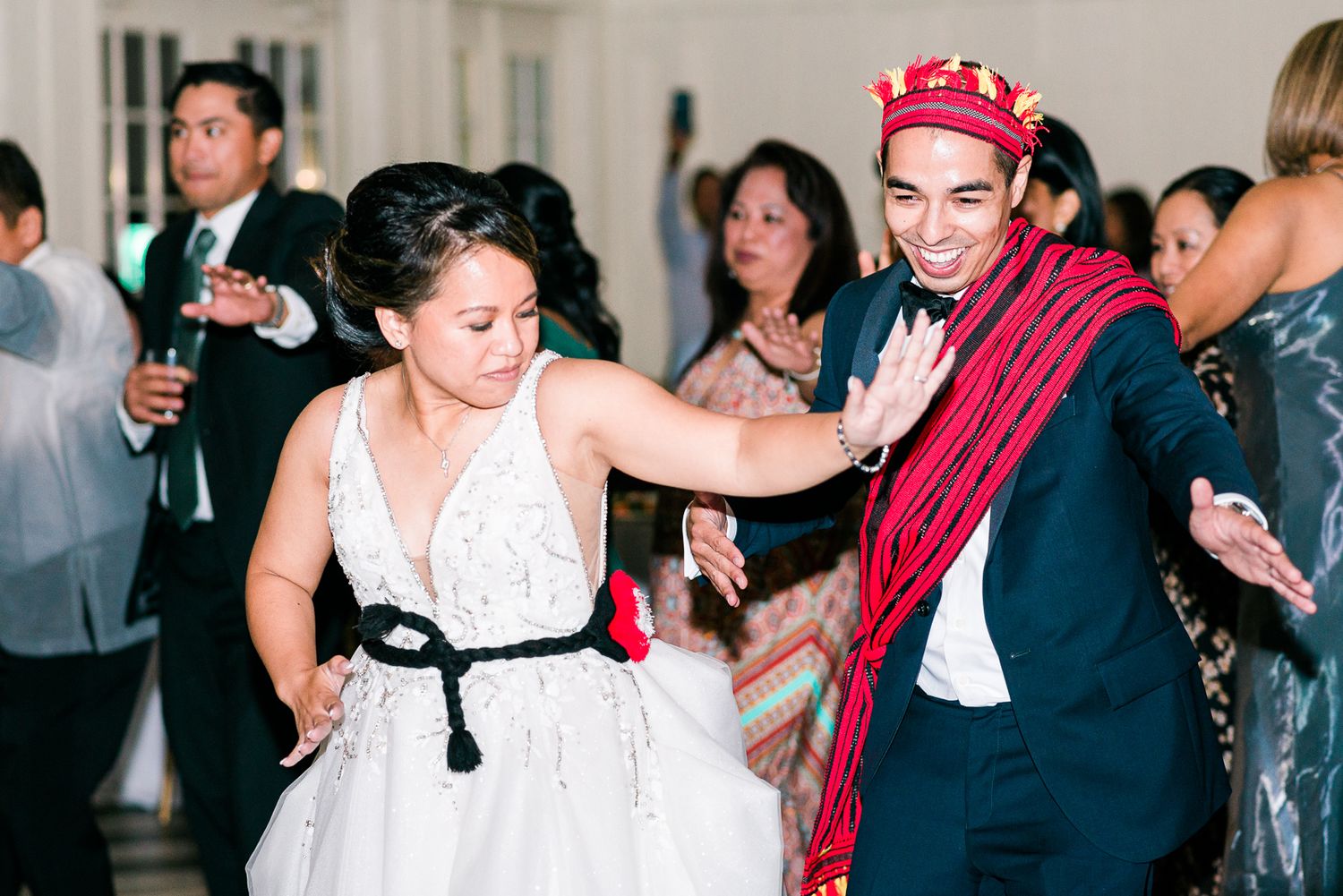 Bride and groom doing a cultural money dance at their wedding reception.