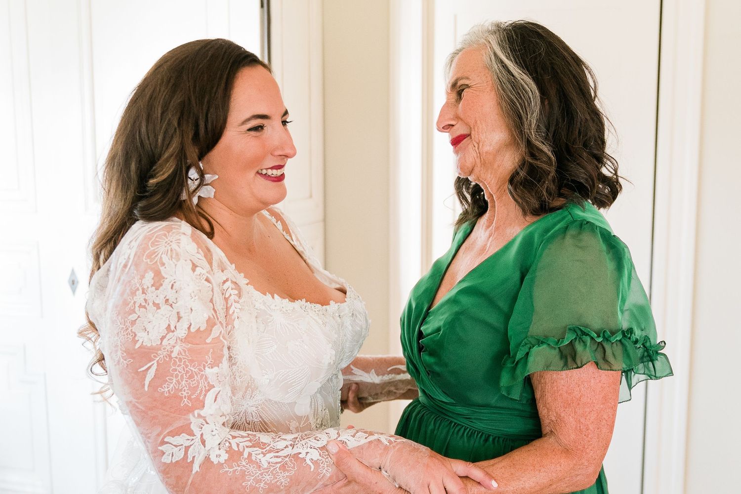 a bride hugs her mother getting ready