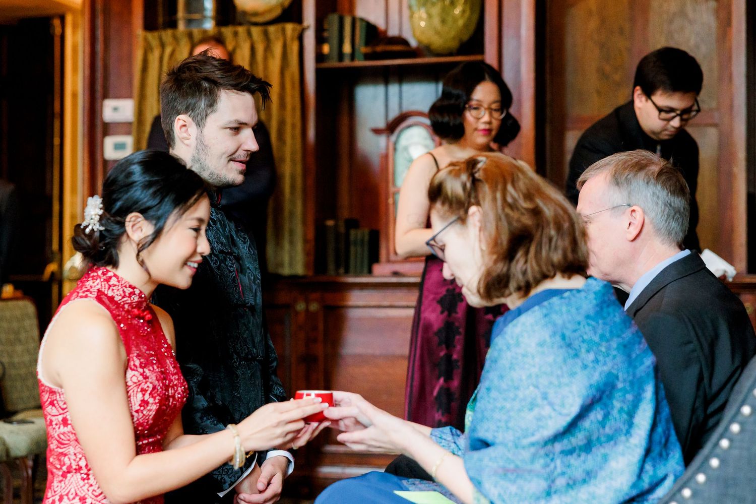A couple receives tea during a traditional Chinese tea ceremony tradition.