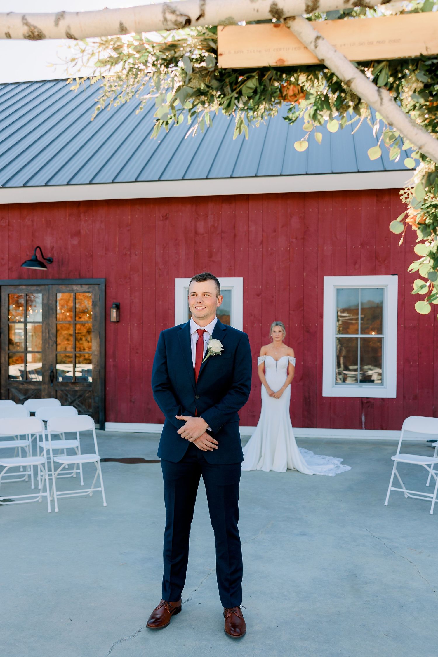 a groom awaits his bride for a first look, the bride is behind him