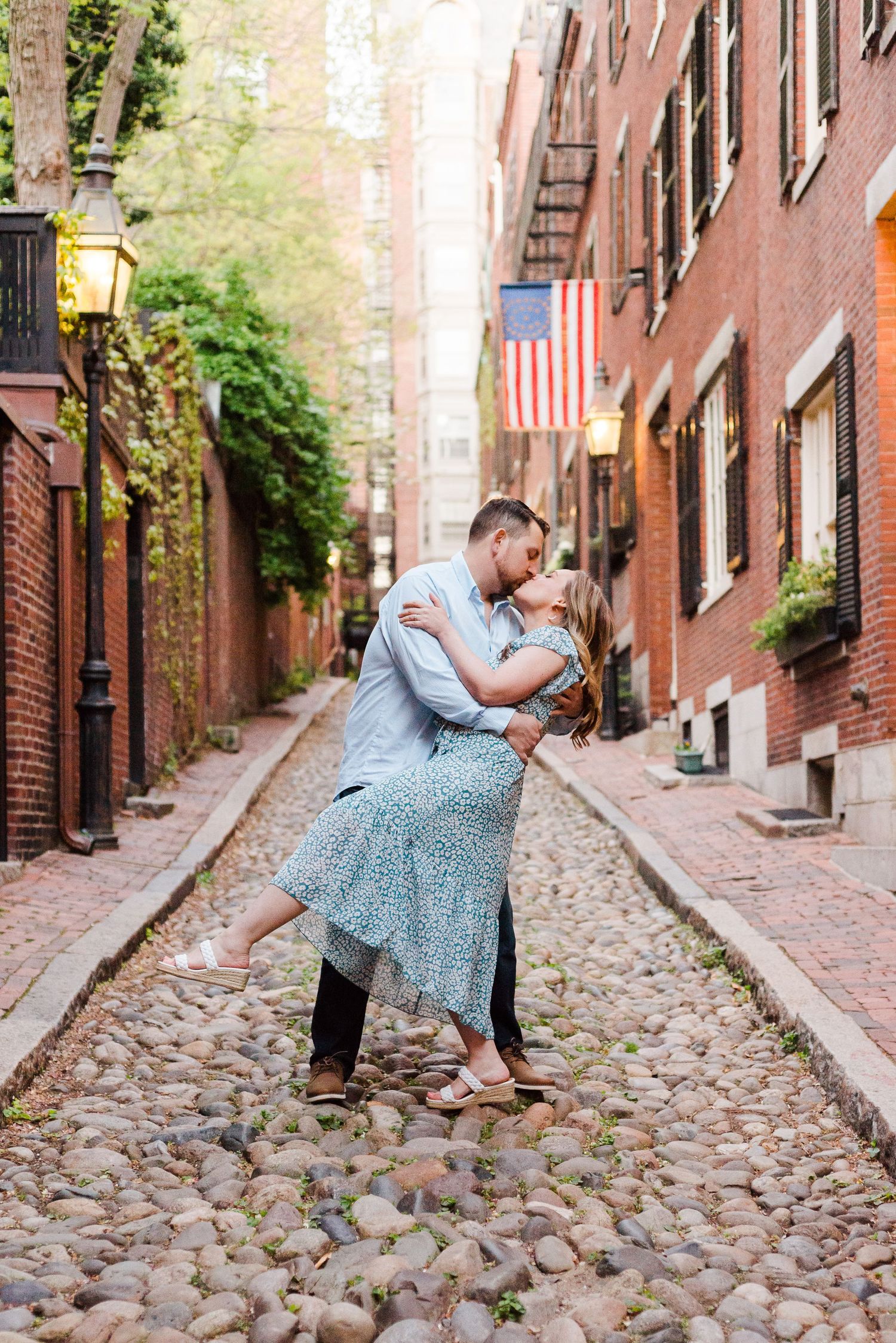 A dipped kiss during an engagement street on Beacon Hill in Boston.
