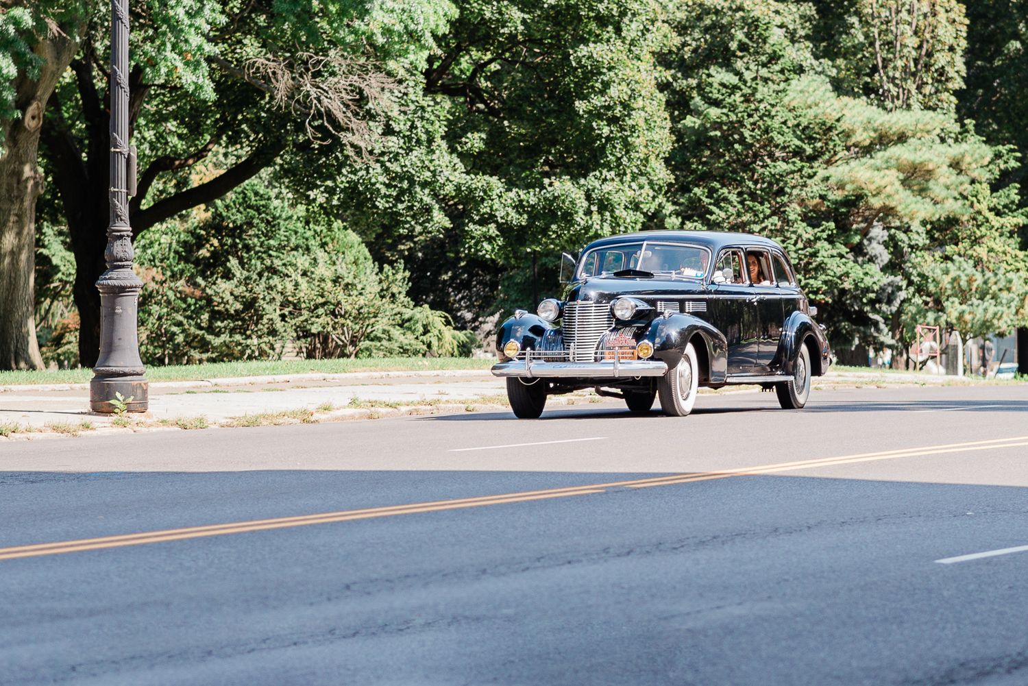 A classic car arriving with the bride for a first look.