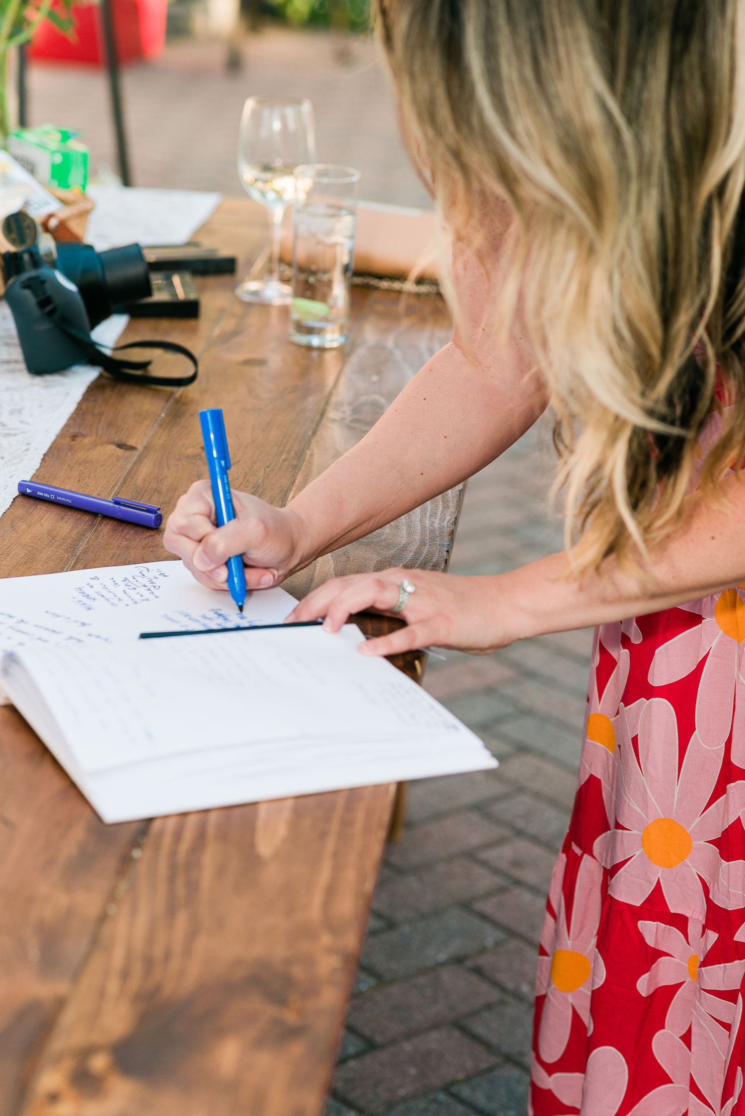 a guest signs a guest book at a wedding reception