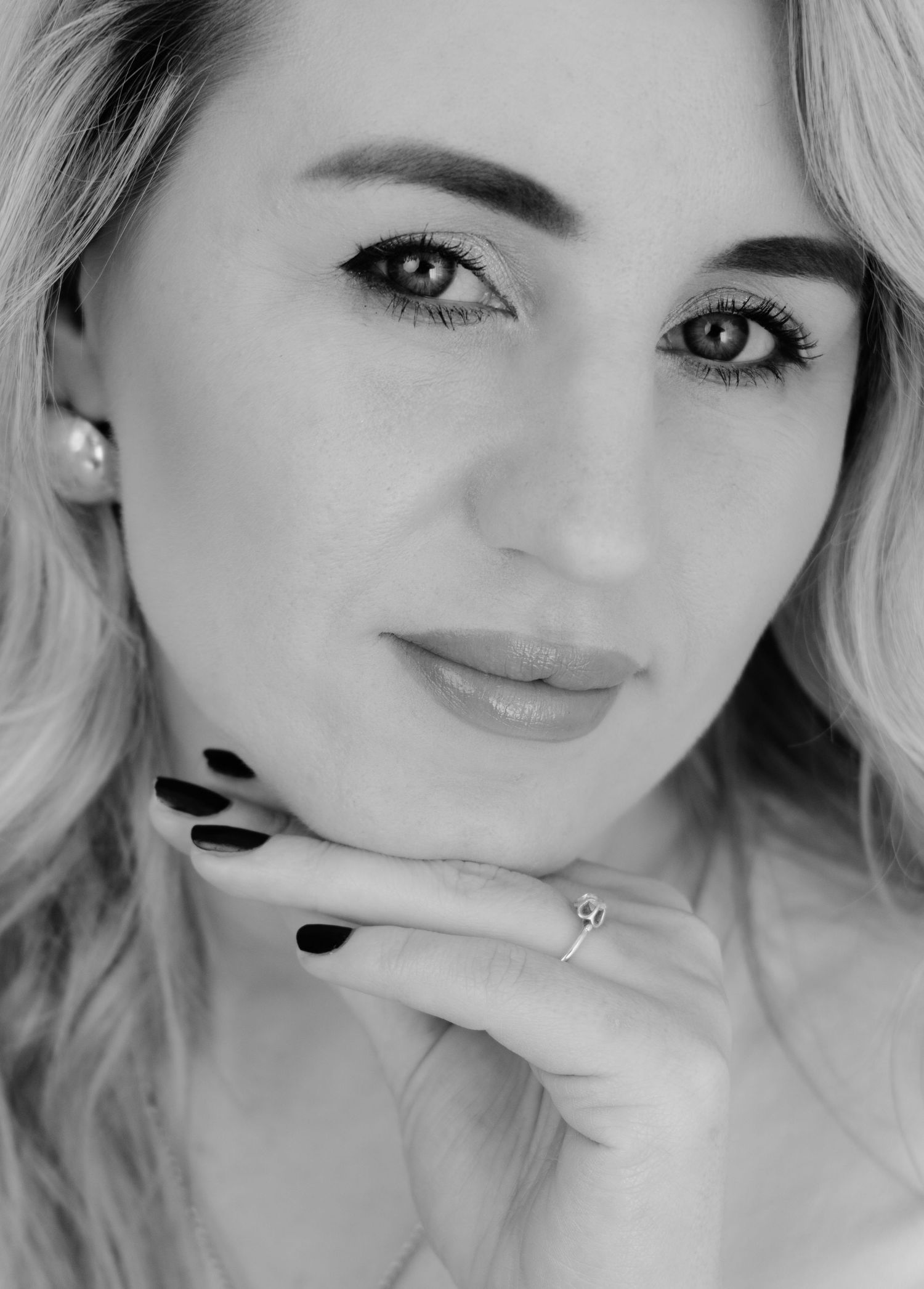 Close-up beauty shots in black and white with minimalist styling.