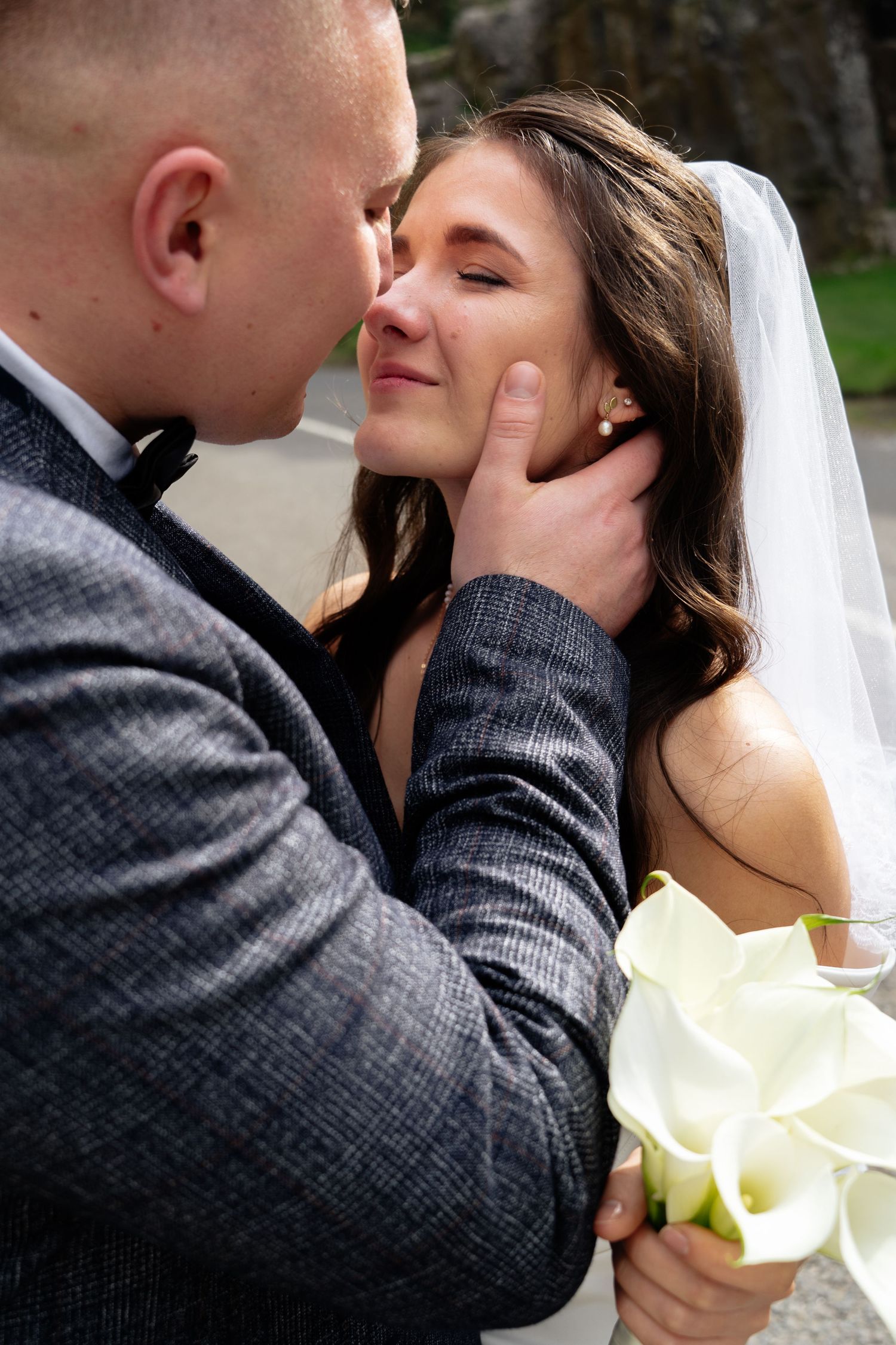 Romantic close-up wedding portrait with white calla lilies.