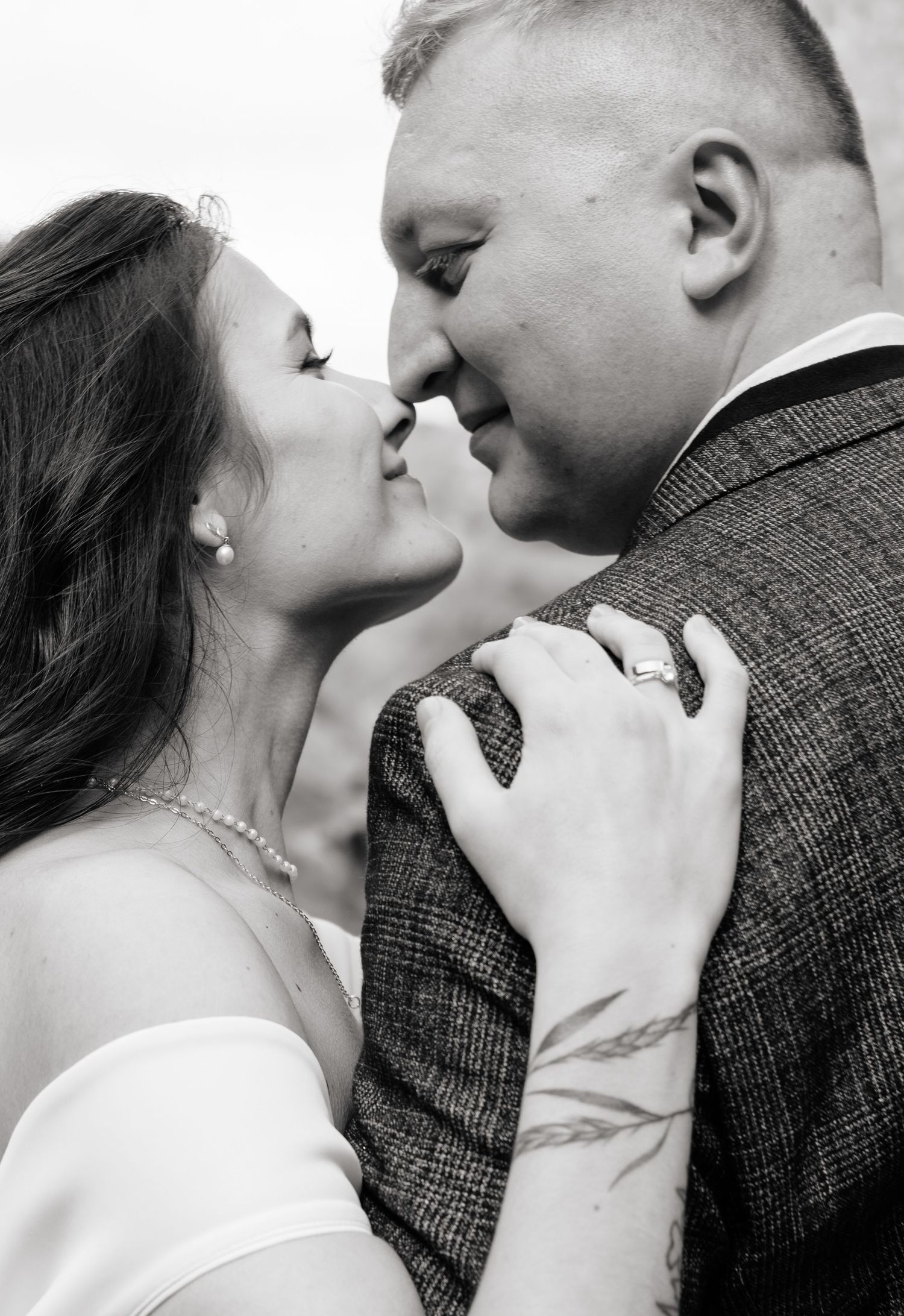Black and white close-up of tender wedding moment.