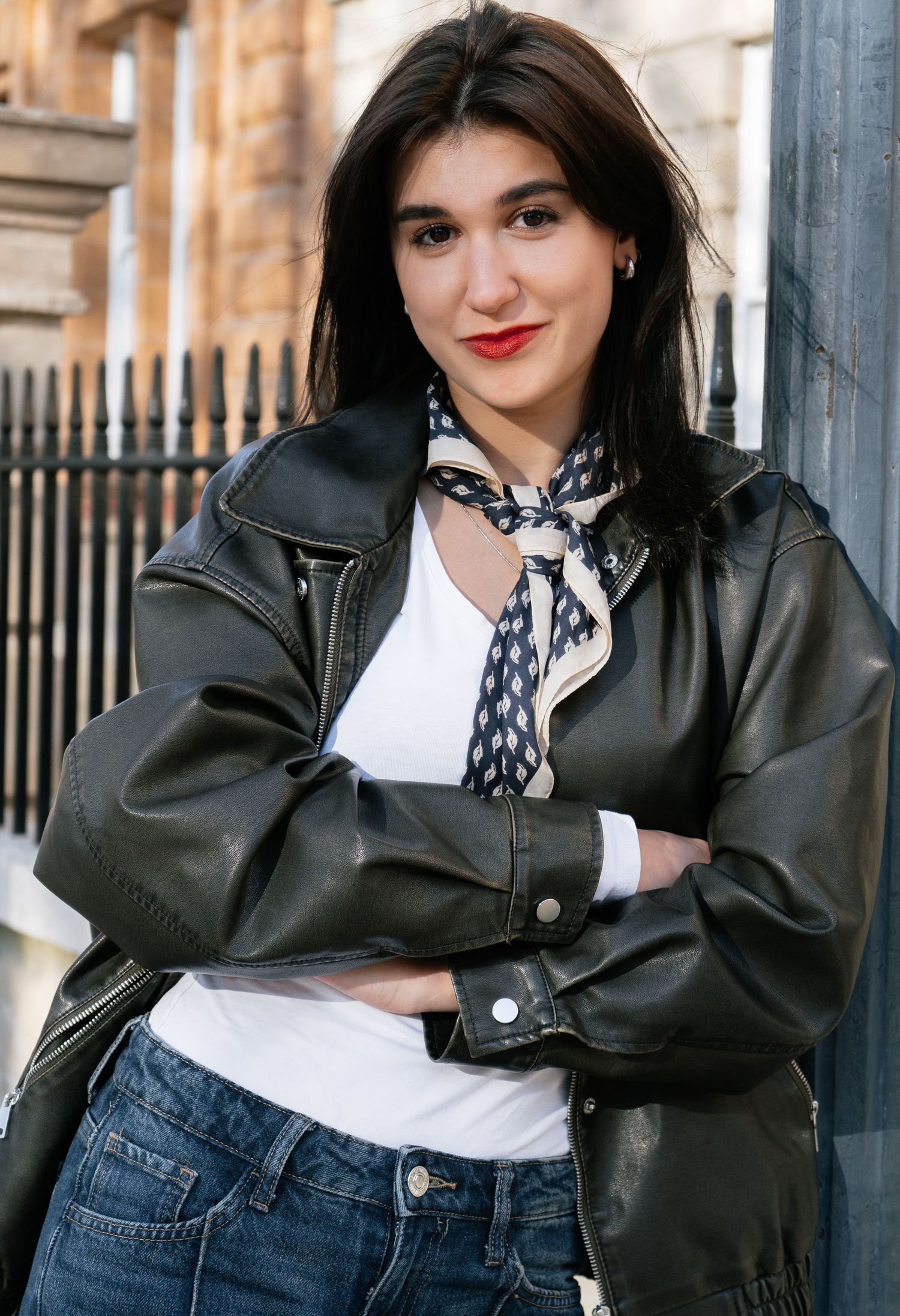 Street style photos featuring black leather jacket, white top and polka dot scarf combination.