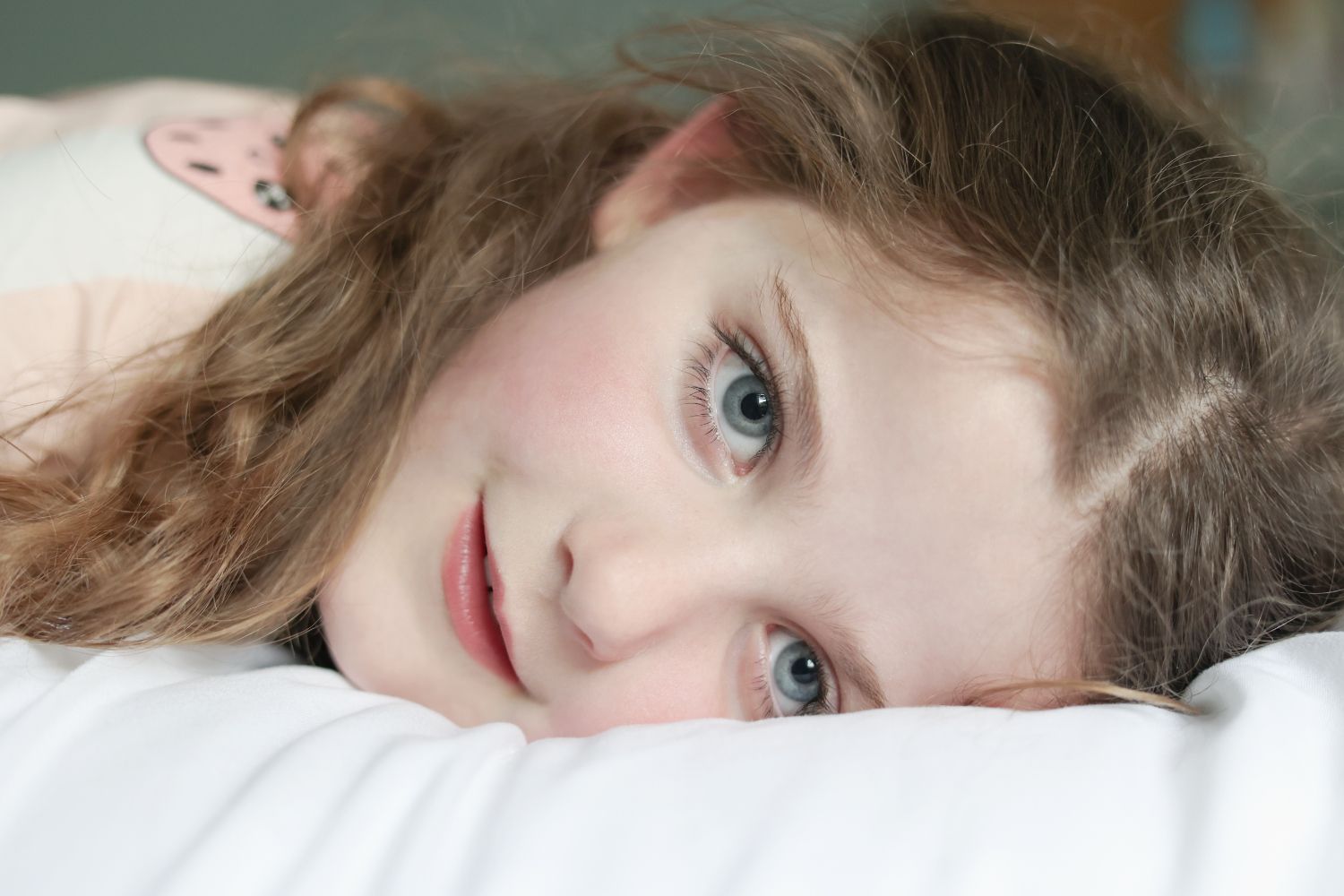 Close up portrait of a child looking directly at the camera with soft natural light
