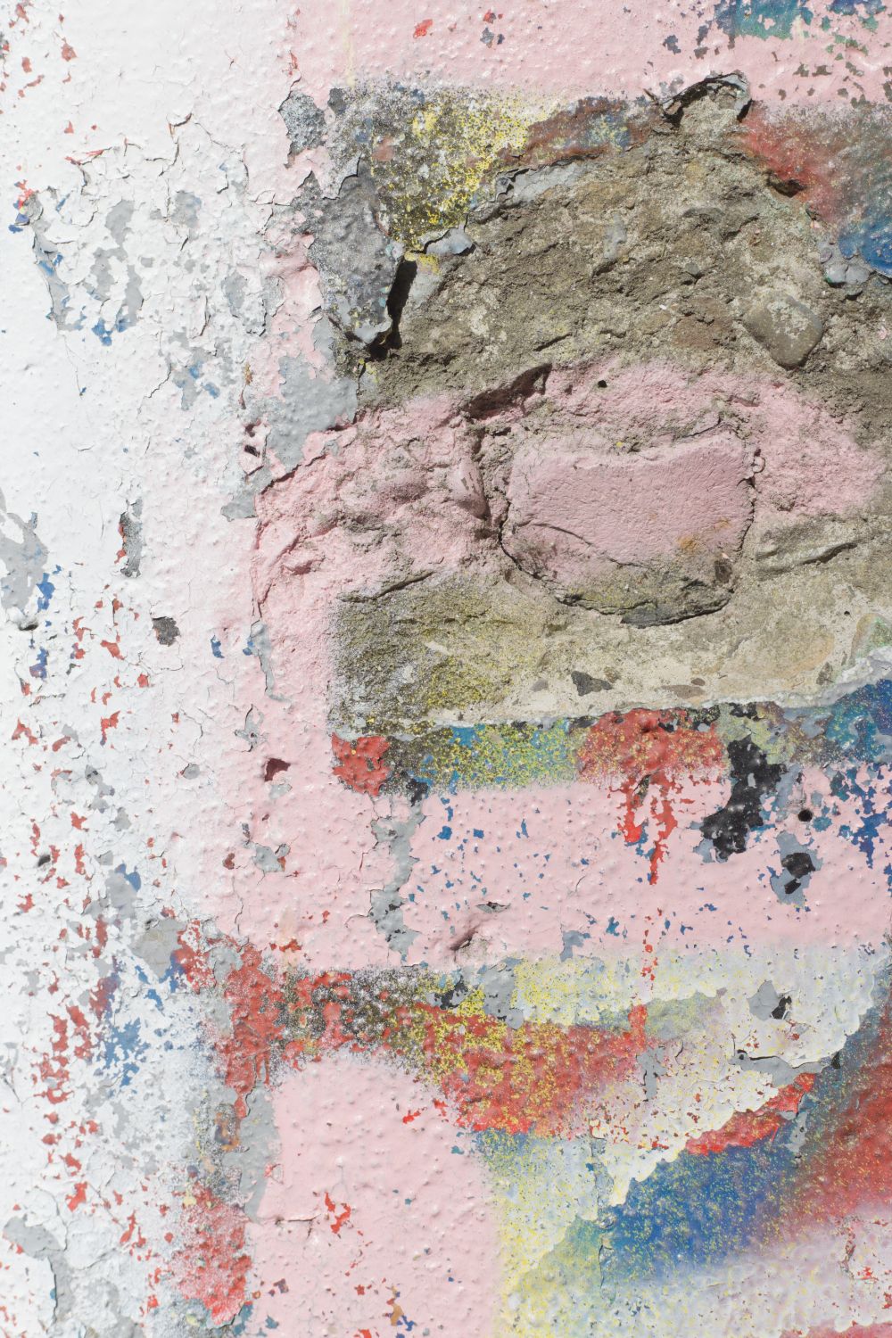 Textured close-up of peeling paint and crumbling plaster showing pink, blue, and grey/green colors with a weathered appearance.