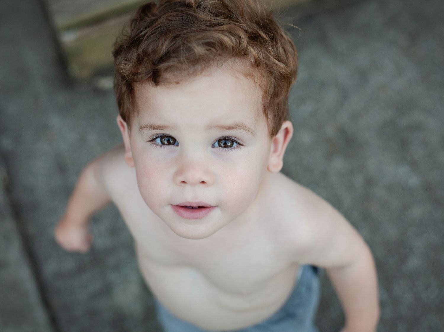 Close up of a small toddler looking directly at the camera