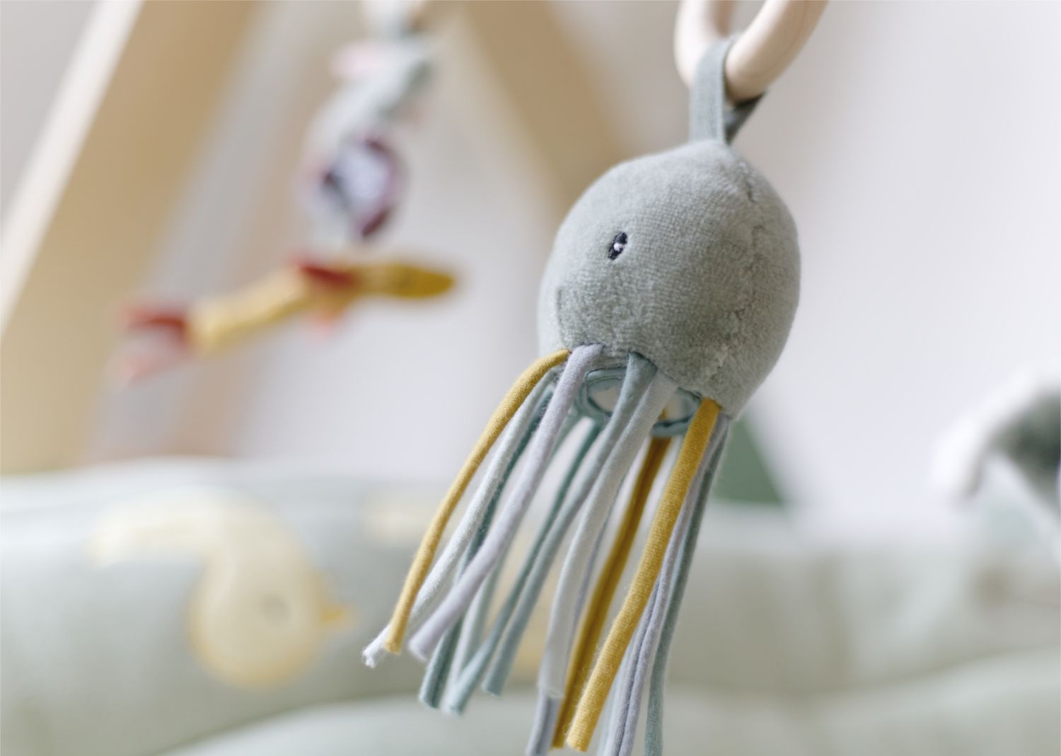 close up detail of a baby octopus soft toy in soft pastel tones