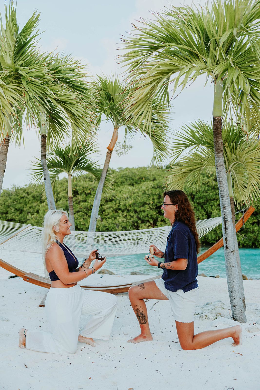 A series of photos showing a person in white shorts doing yoga poses on a tropical beach with palm trees.