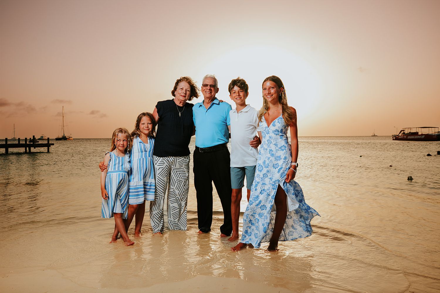 Family portrait with palm trees in Aruba during golden hour