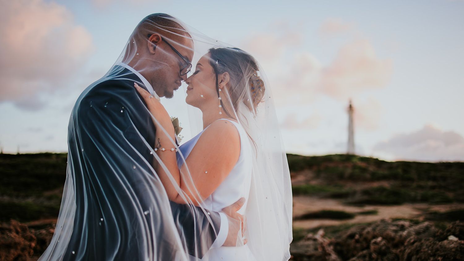 Aruba wedding couple sharing a kiss at sunset on Palm Beach