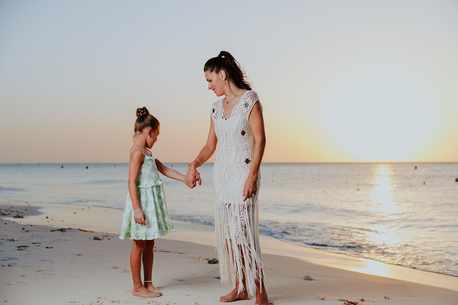 Mother and daughter enjoying a sunset family photoshoot on Aruba beach