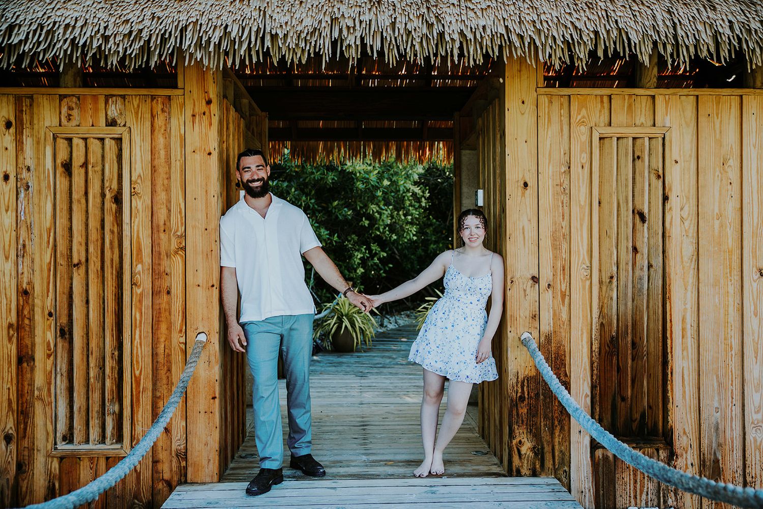 A series of candid moments captured at a rustic wooden cabin with a thatched roof during a casual outdoor gathering.