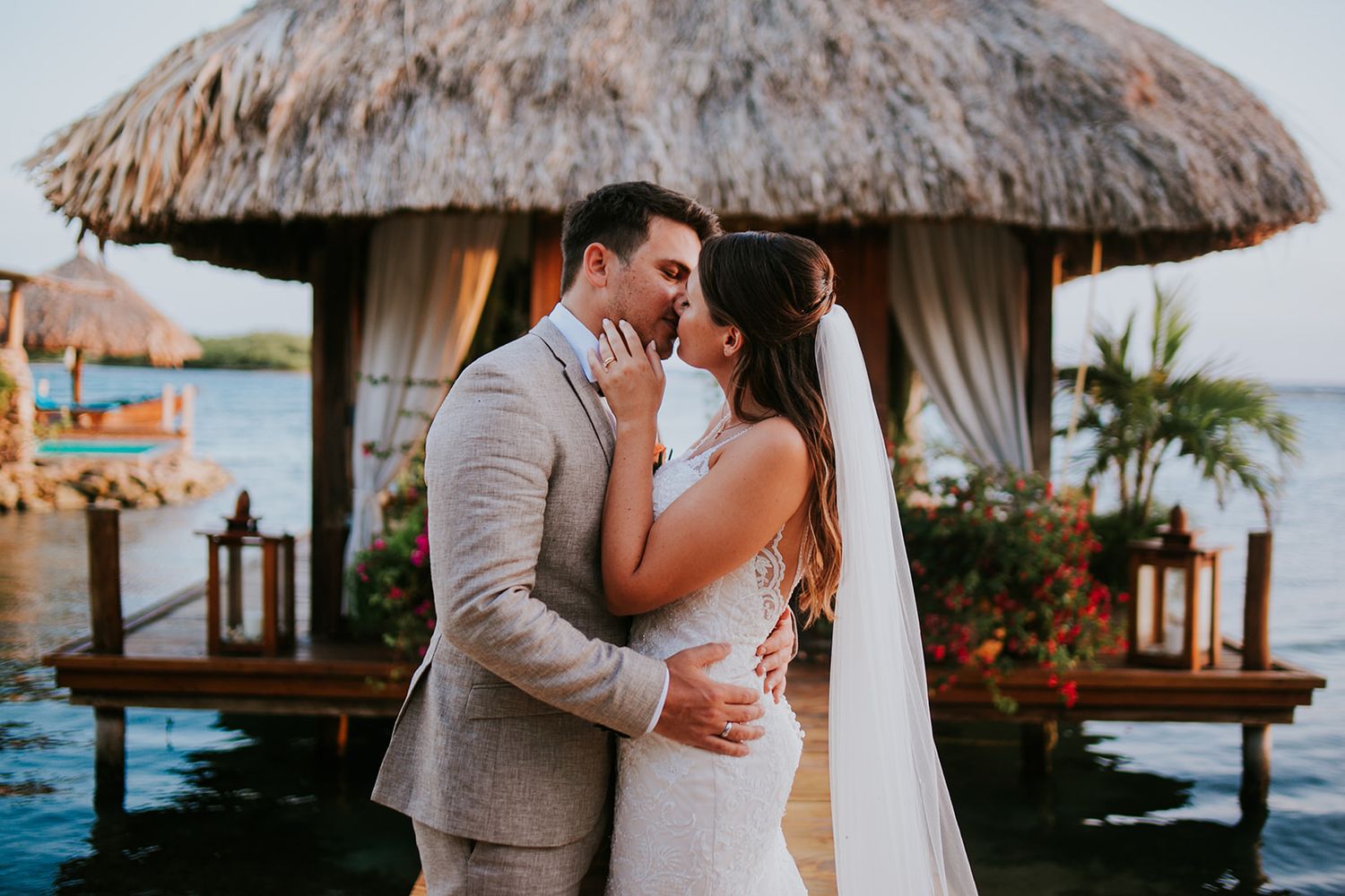 A romantic moment captured at an overwater bungalow with tropical decor and ocean views.