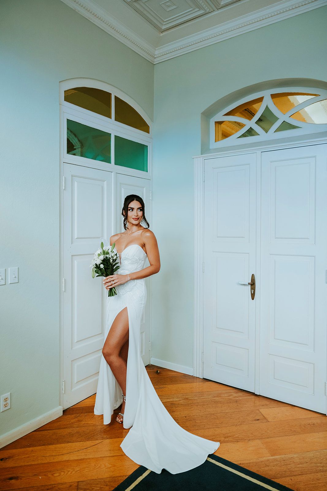 Artistic poses of a bride in a flowing white gown showing the dress movement in an elegant interior setting.