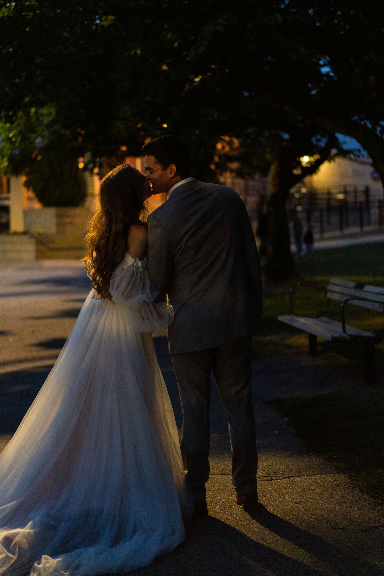 Series of evening shots showing a couple in wedding attire with dramatic lighting.