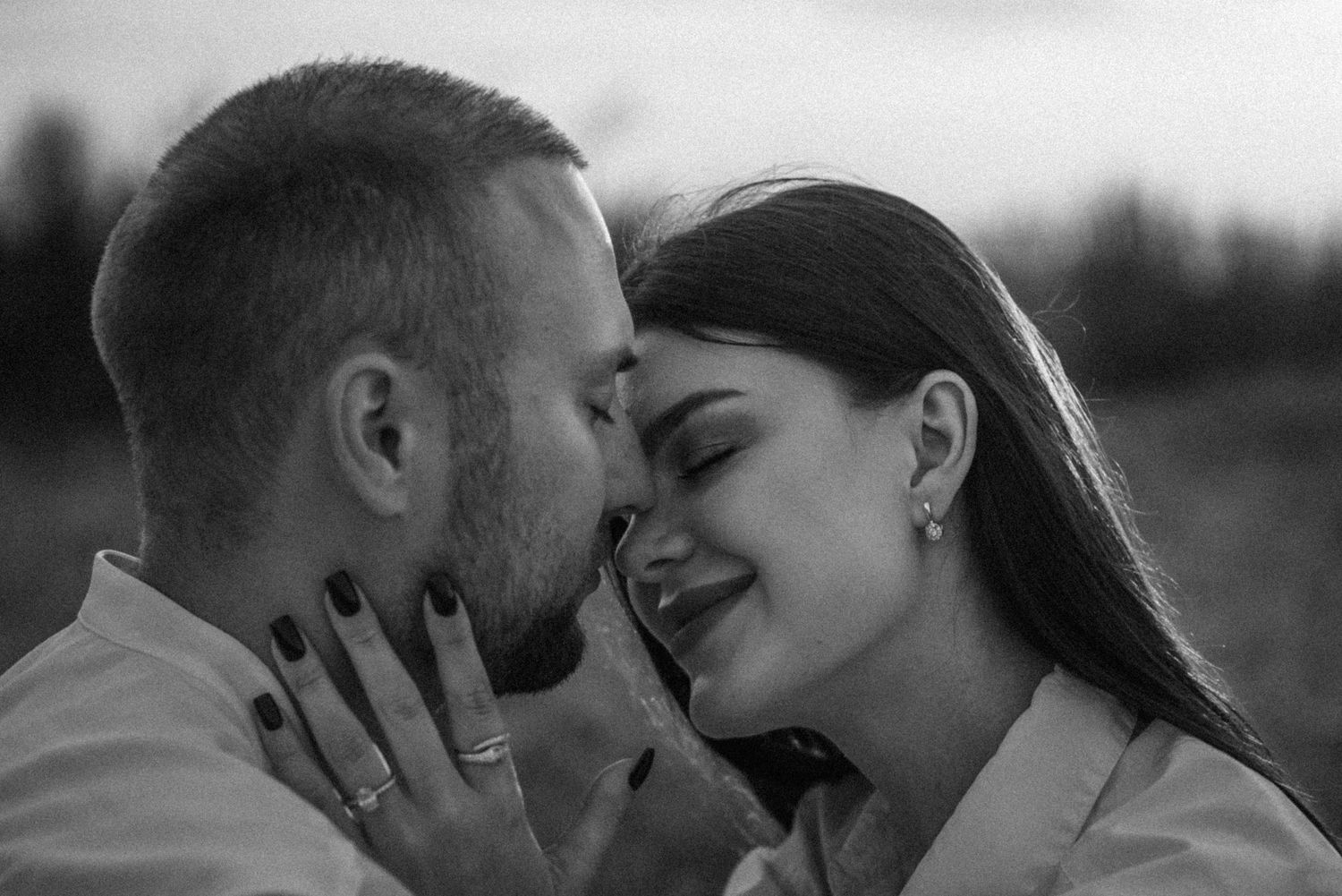 A series of romantic black and white photos showing a couple embracing and kissing in various tender moments.