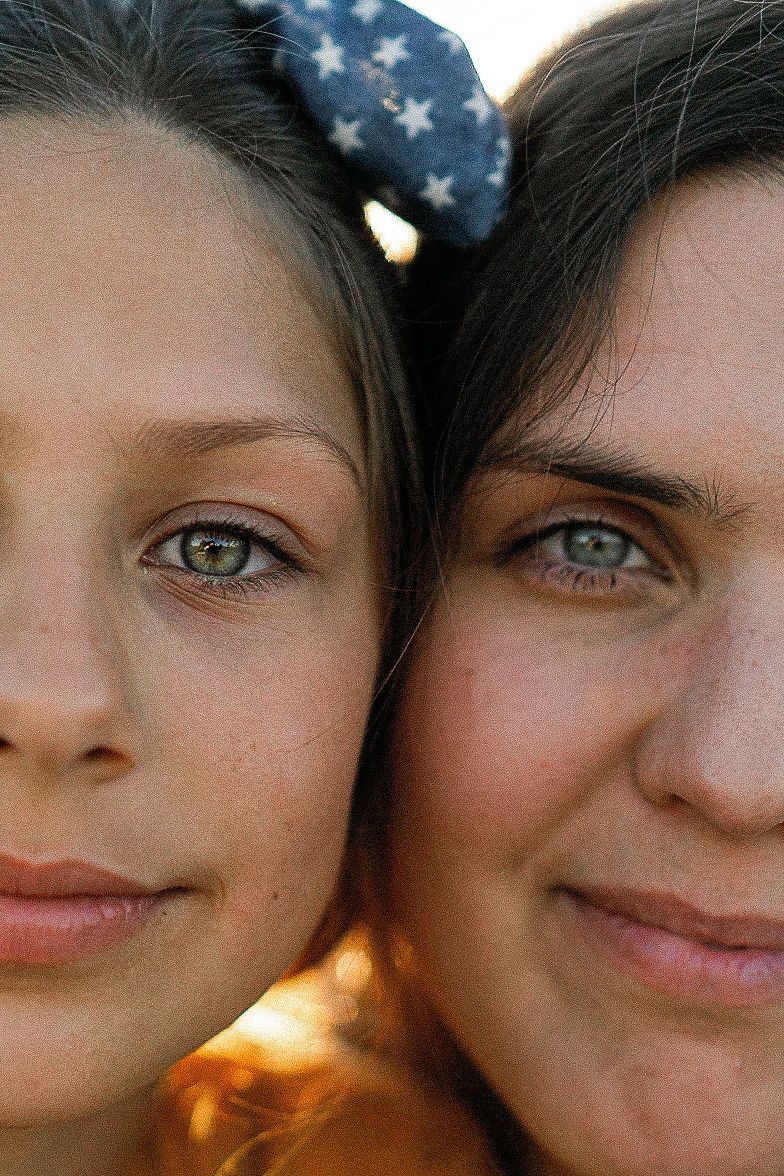 Close up portrait series showing expressions and American flag backdrop with ambient lighting.