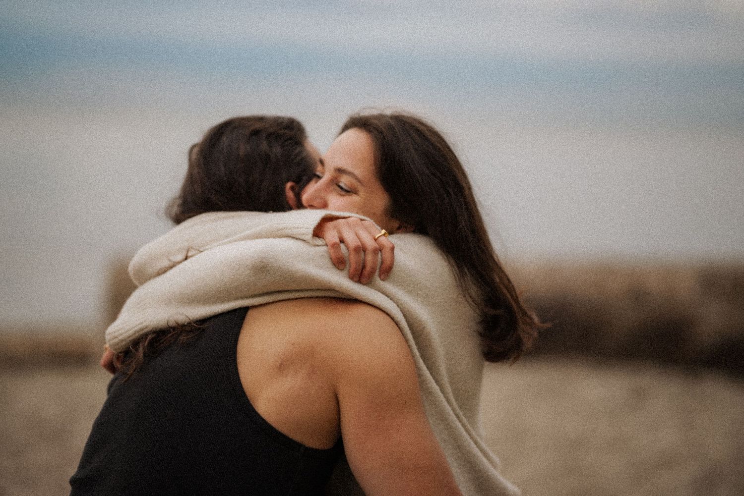 Romantic couples embracing and kissing in a softly lit indoor setting.