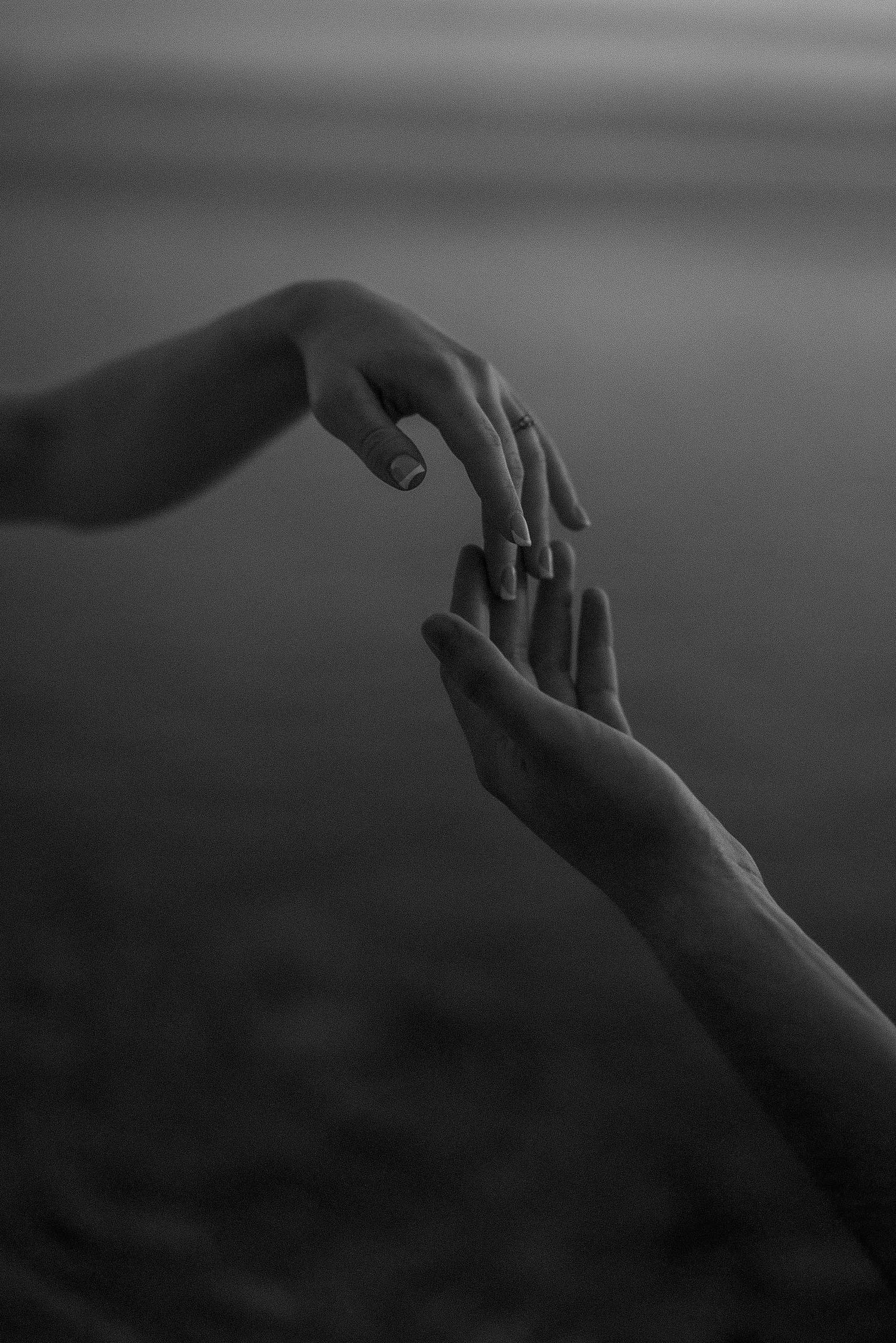 Artistic series of hand gestures against dark moody background.