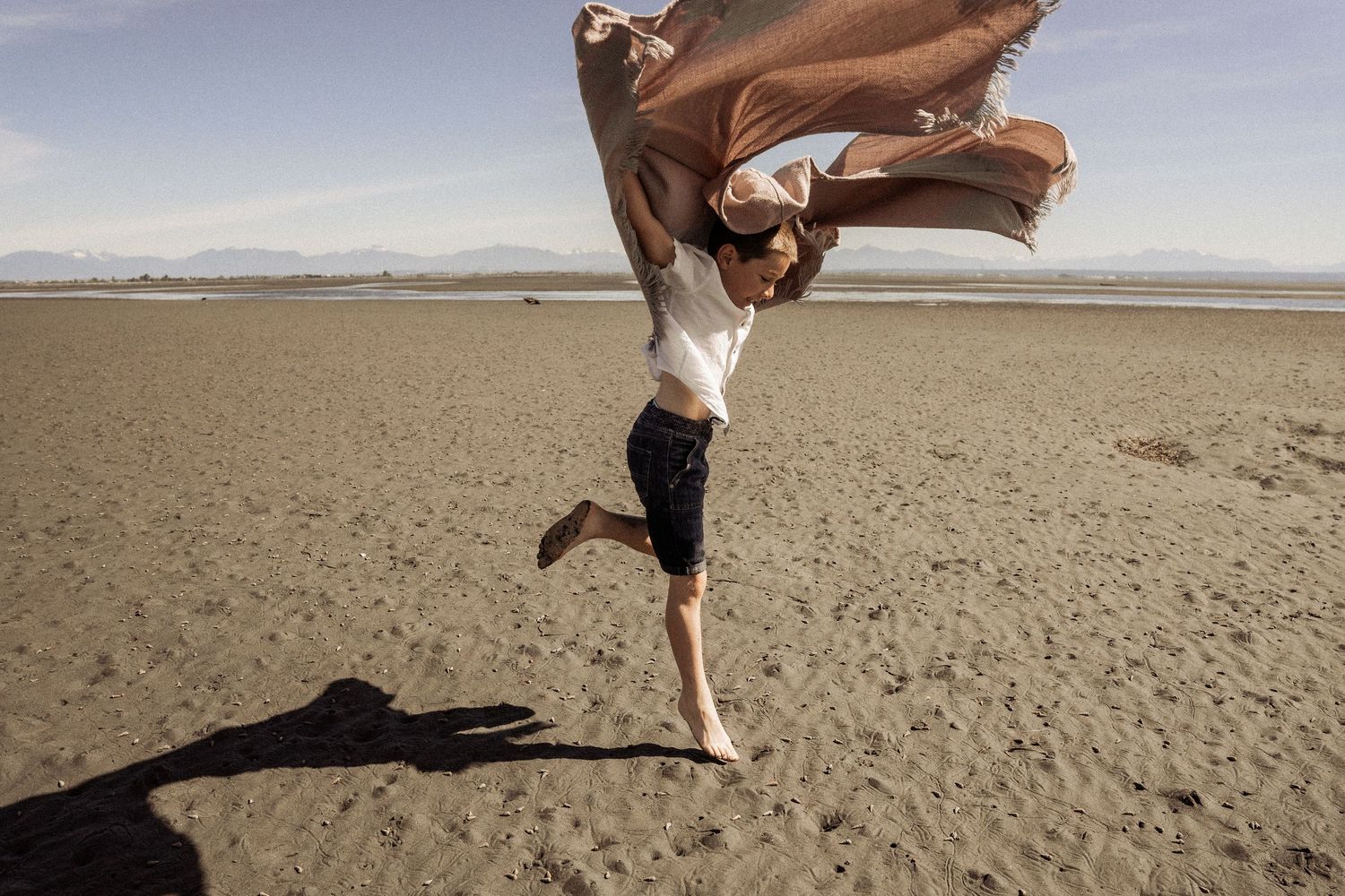 Dynamic beach sequence showing playful moments with bare feet in the sand.