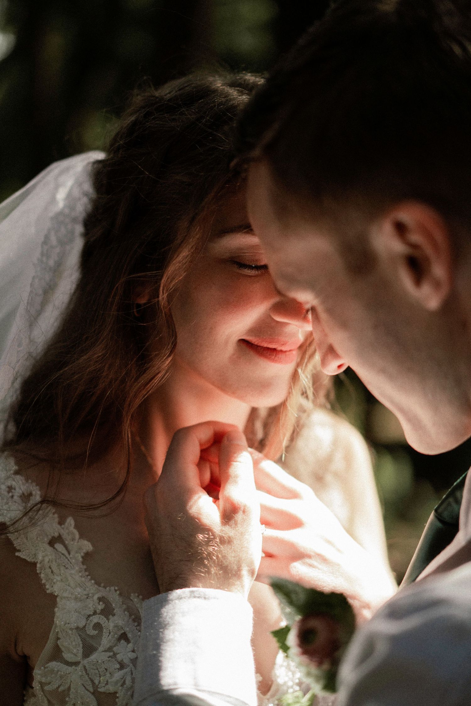 Intimate wedding portrait with soft natural lighting creating a romantic atmosphere.