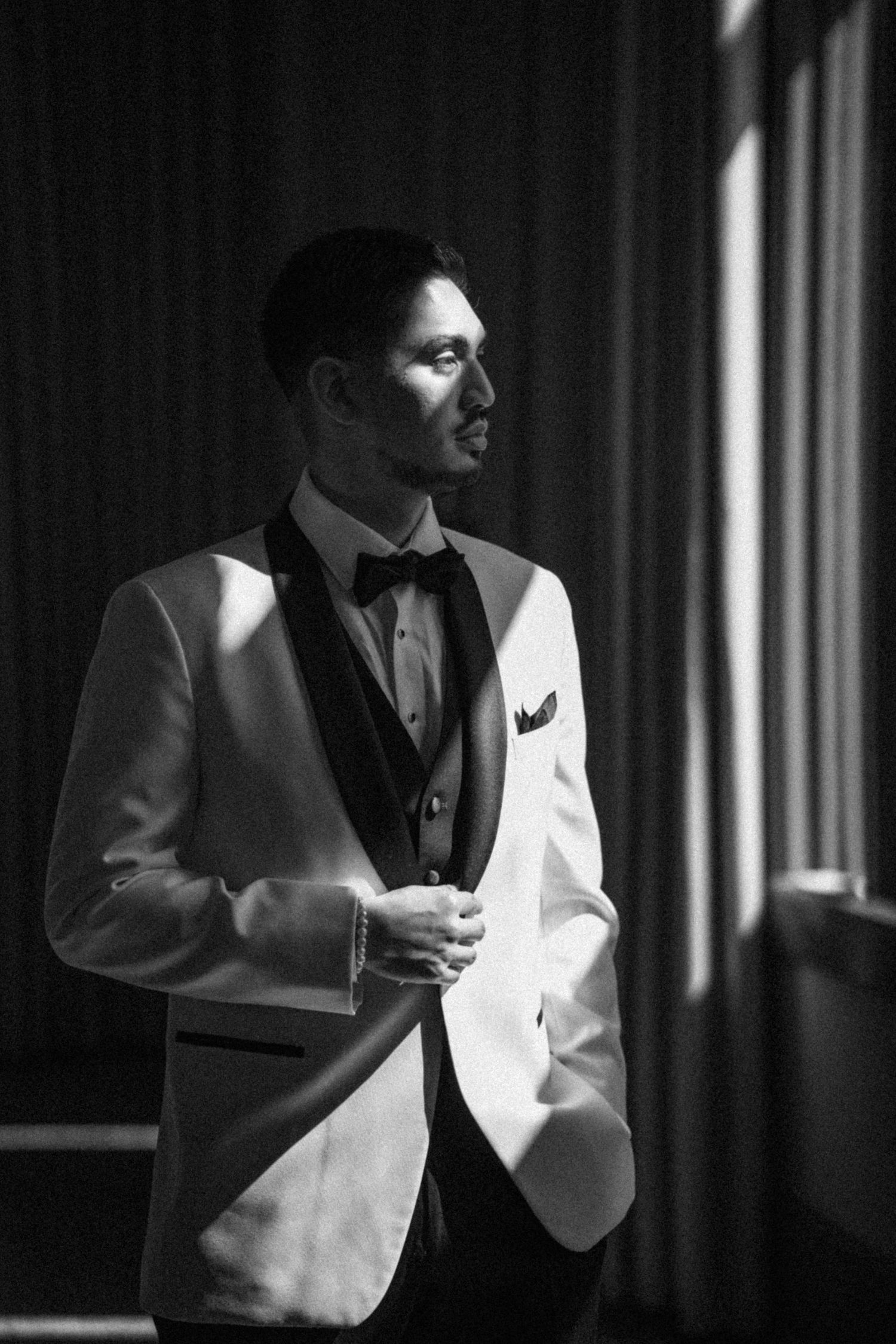 Dramatic black and white portraits in formal attire with striking lighting.