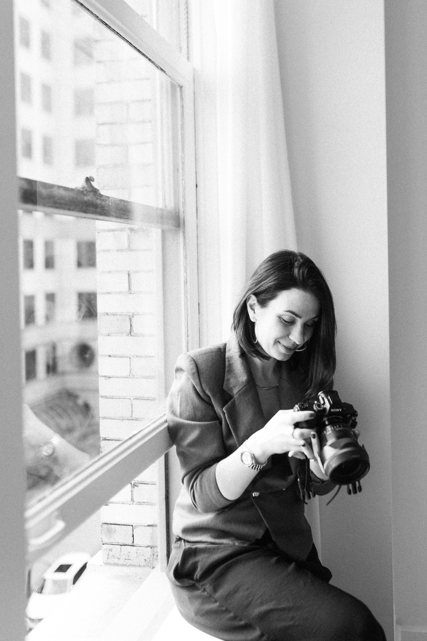 Artistic sequence of photographer at work by bright window in urban setting.