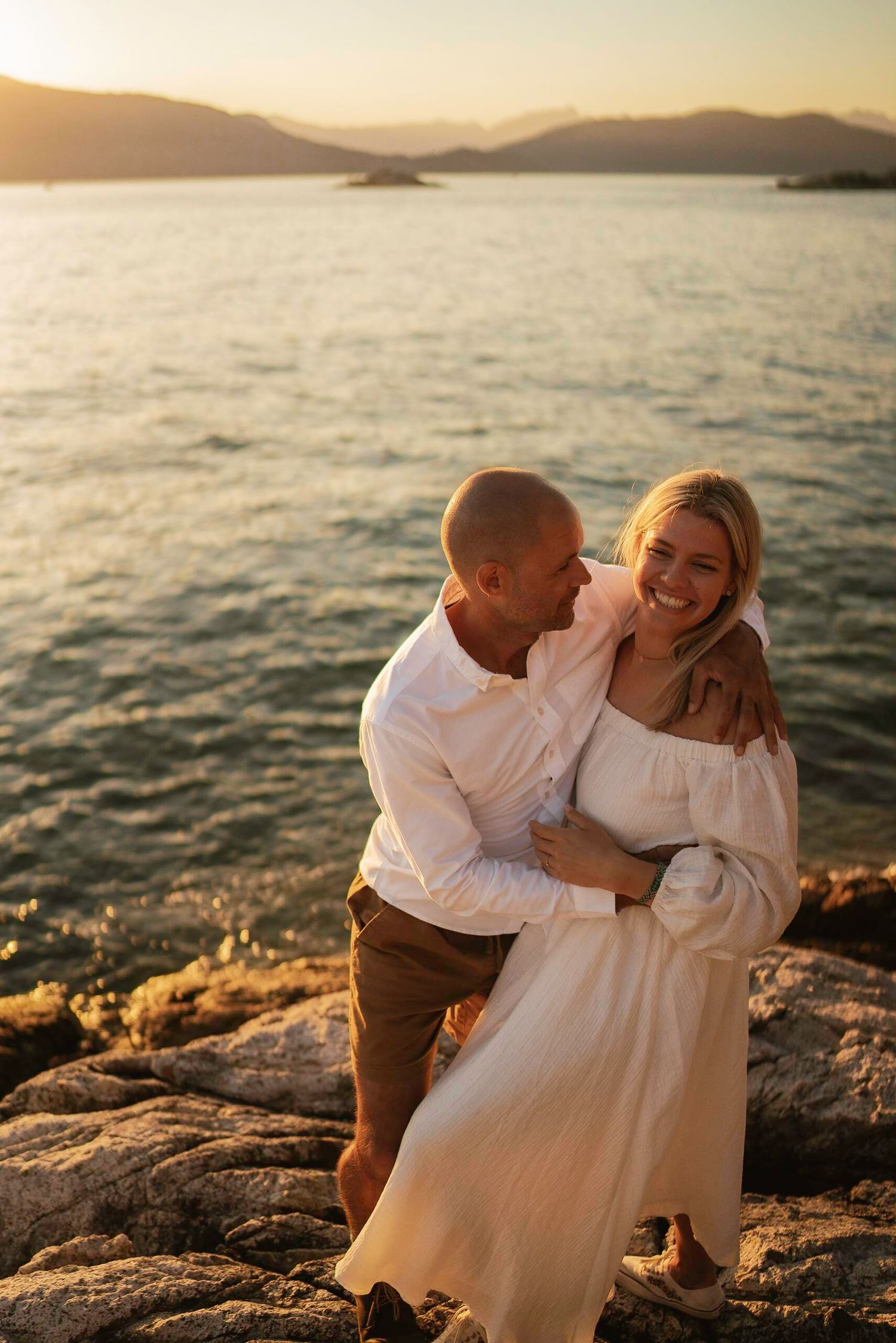 Romantic sunset moment on rocky coastal overlook.