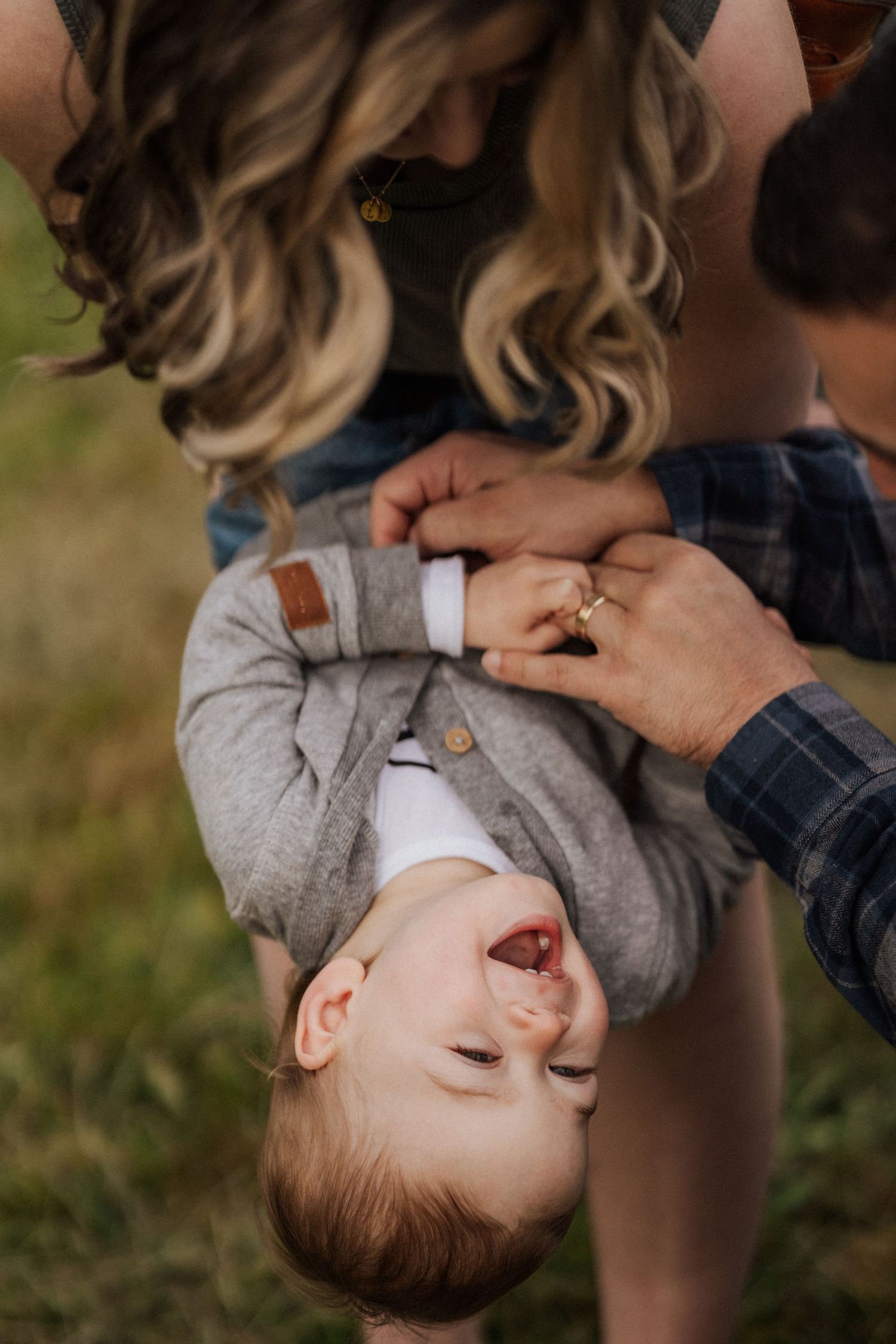 A playful upside-down moment captured during outdoor family photography.