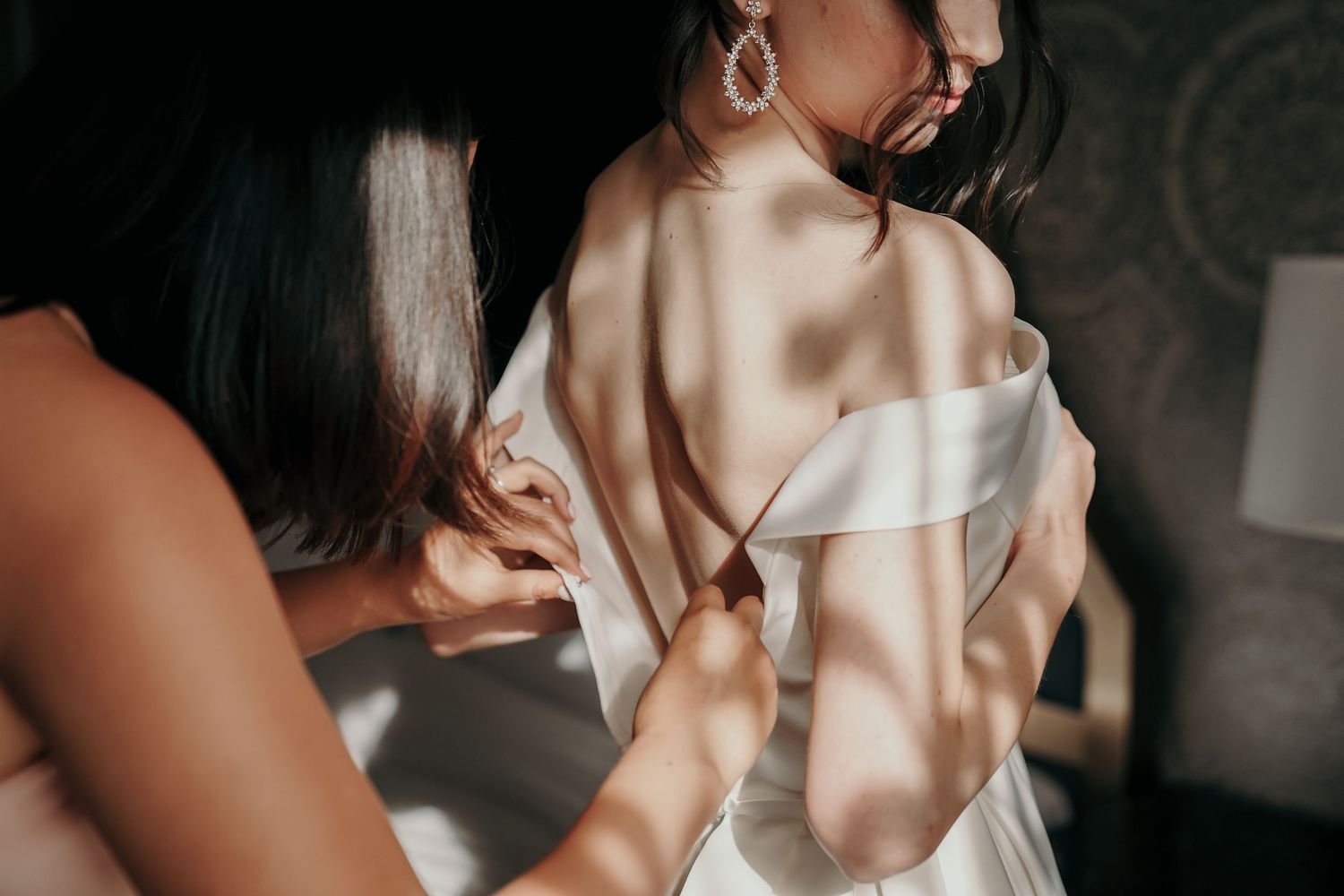 Artistic close-up shots of a bride in a white dress with dramatic lighting.