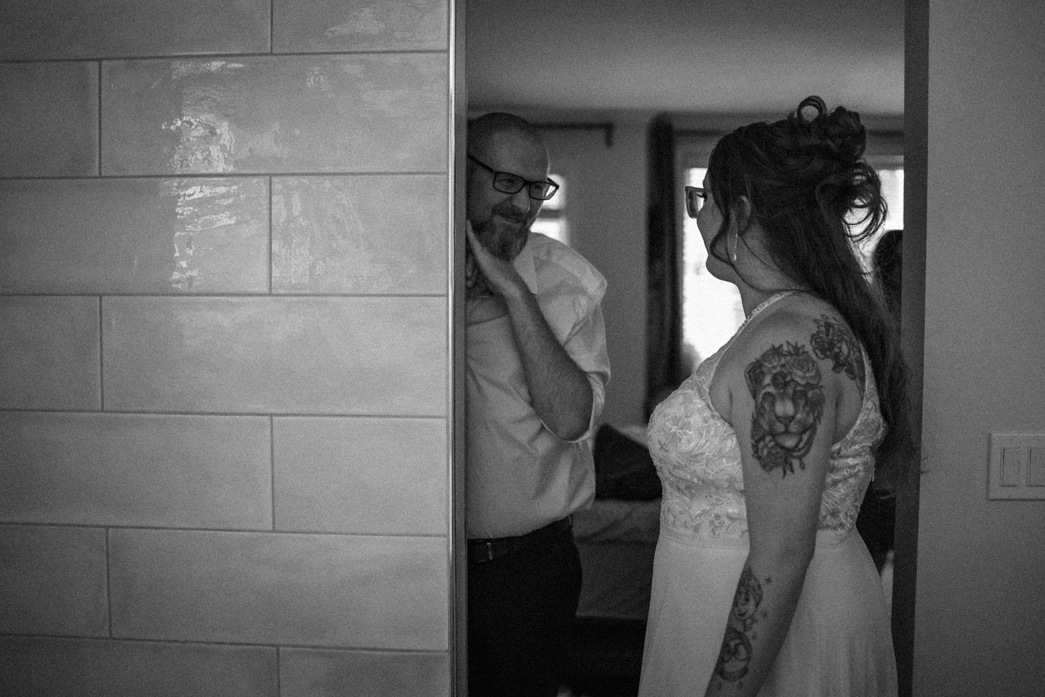Black and white wedding photo series showing emotional moments between couples and family members in doorways and hallways.