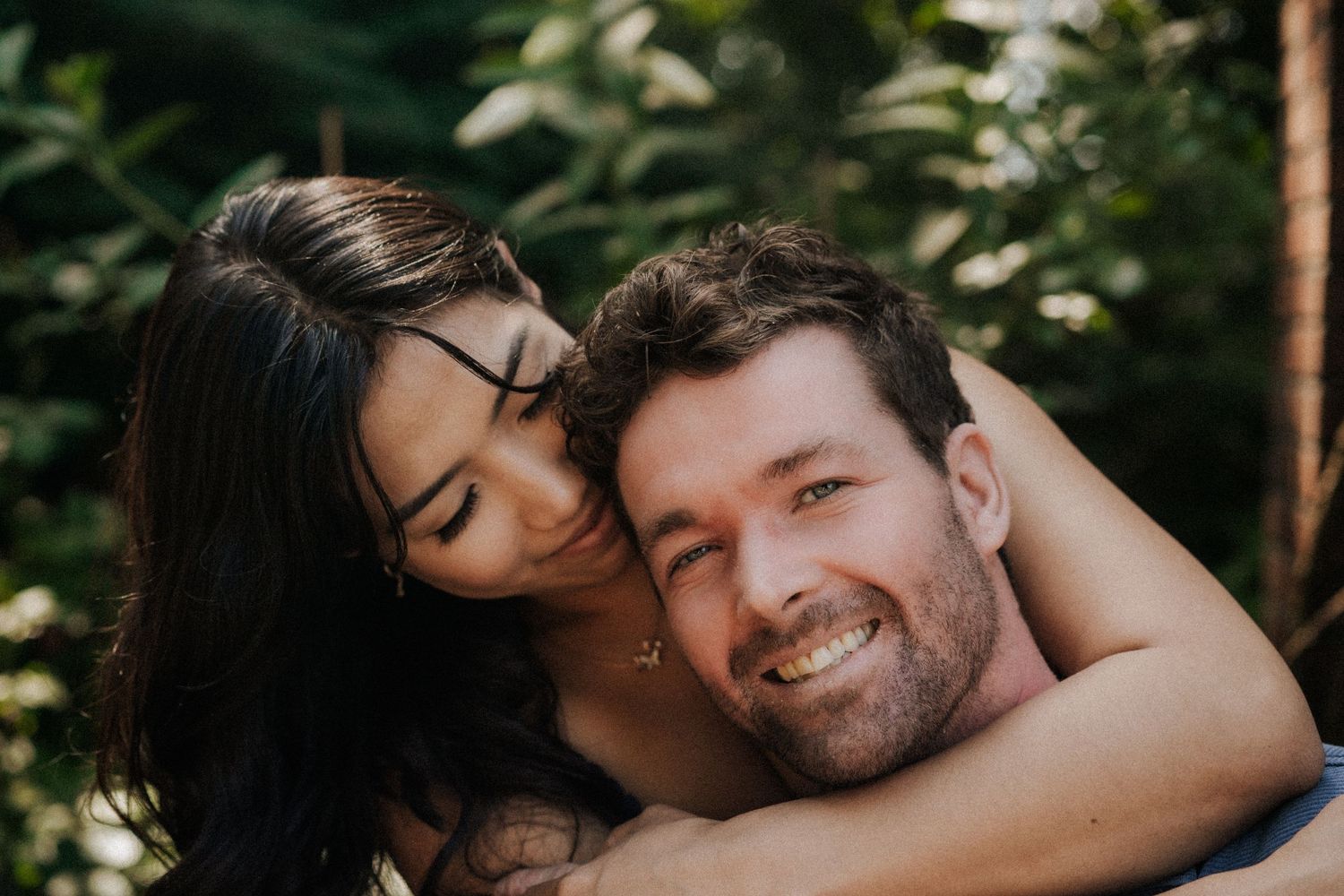 Candid outdoor engagement photos showing joyful casual moments in natural lighting.