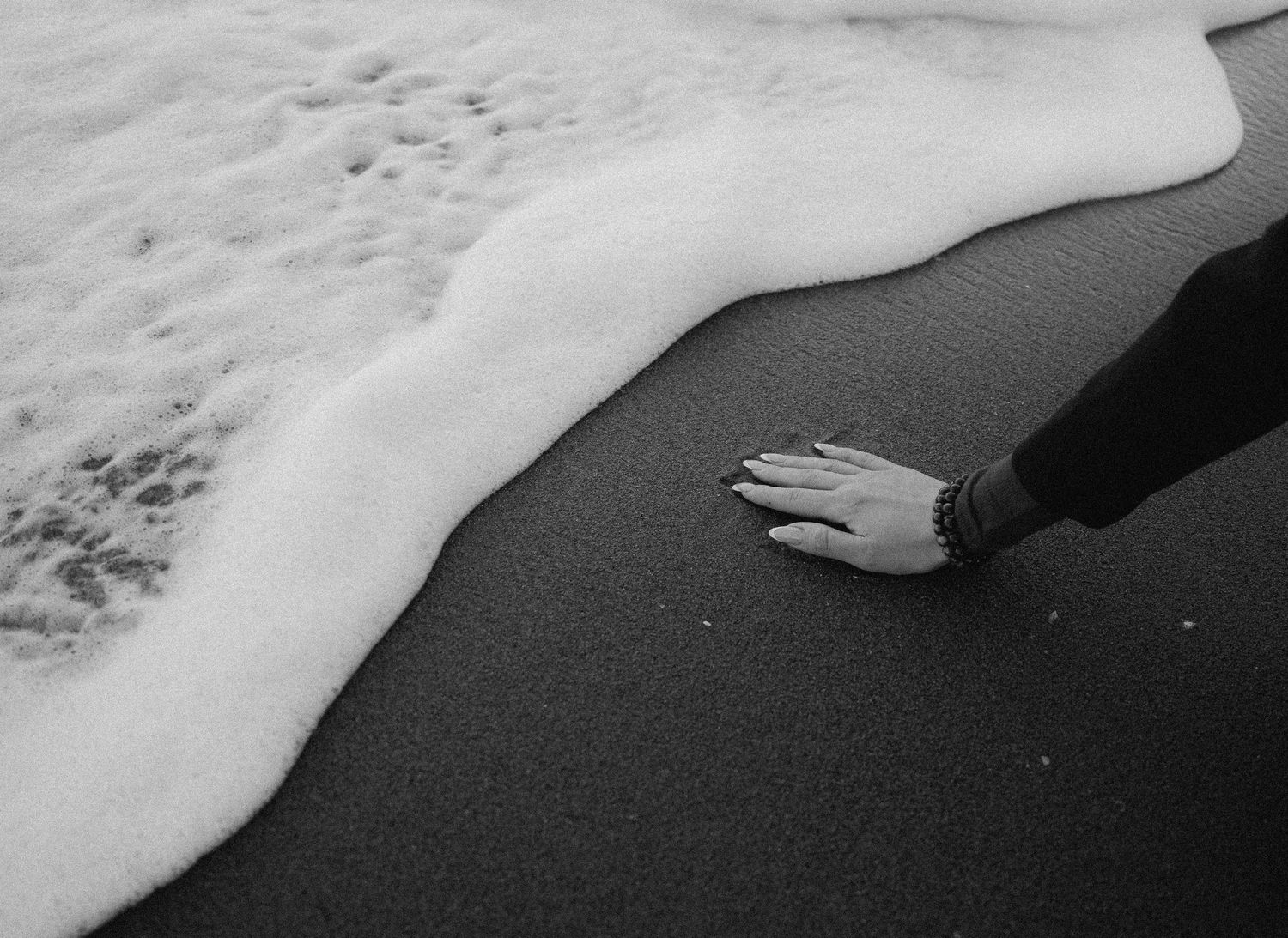 Black and white photo sequence showing ocean waves rolling onto a beach shore in a rhythmic pattern.
