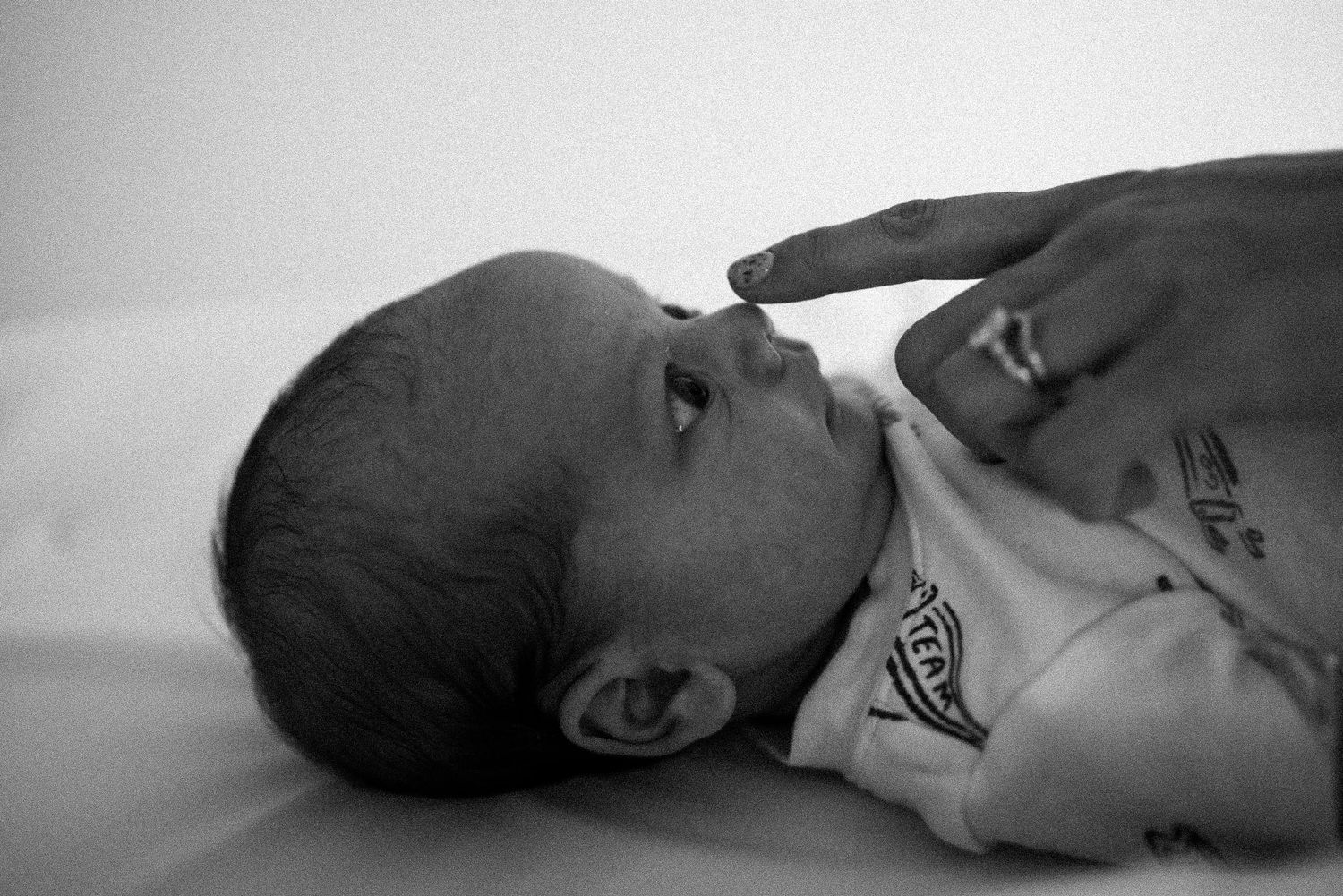A series of black and white ultrasound images showing different stages of fetal development during pregnancy.