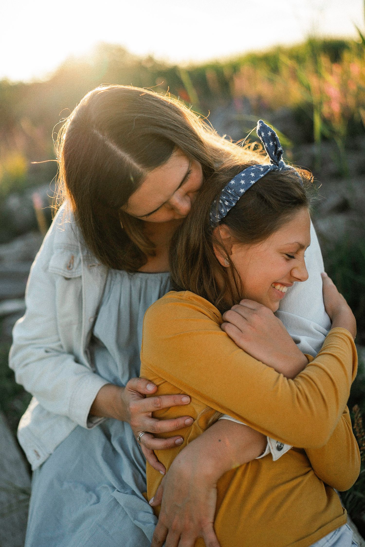 Emotional embraces captured in warm evening light.
