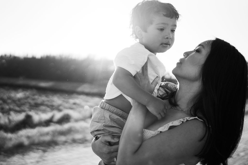 Black and white intimate portraits showing tender parent-child moments.