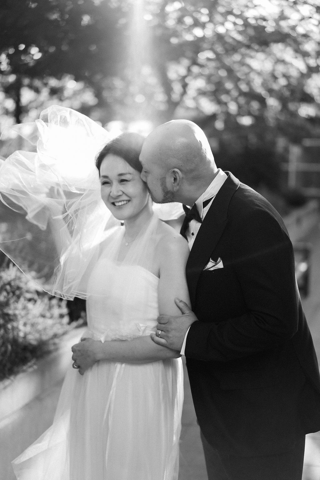 Black and white outdoor wedding portraits capturing joyful romantic moments.