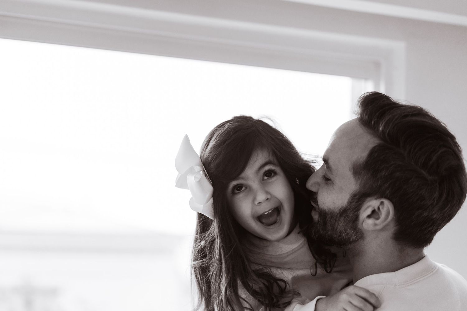 Black and white photo series capturing intimate moments between a couple indoors.