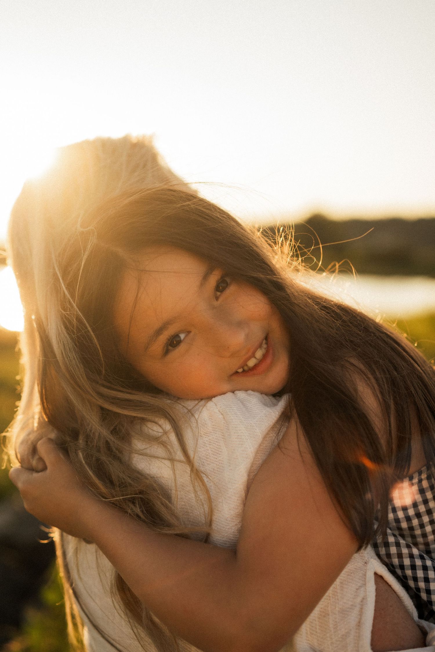 A candid portrait sequence backlit by warm golden sunlight.