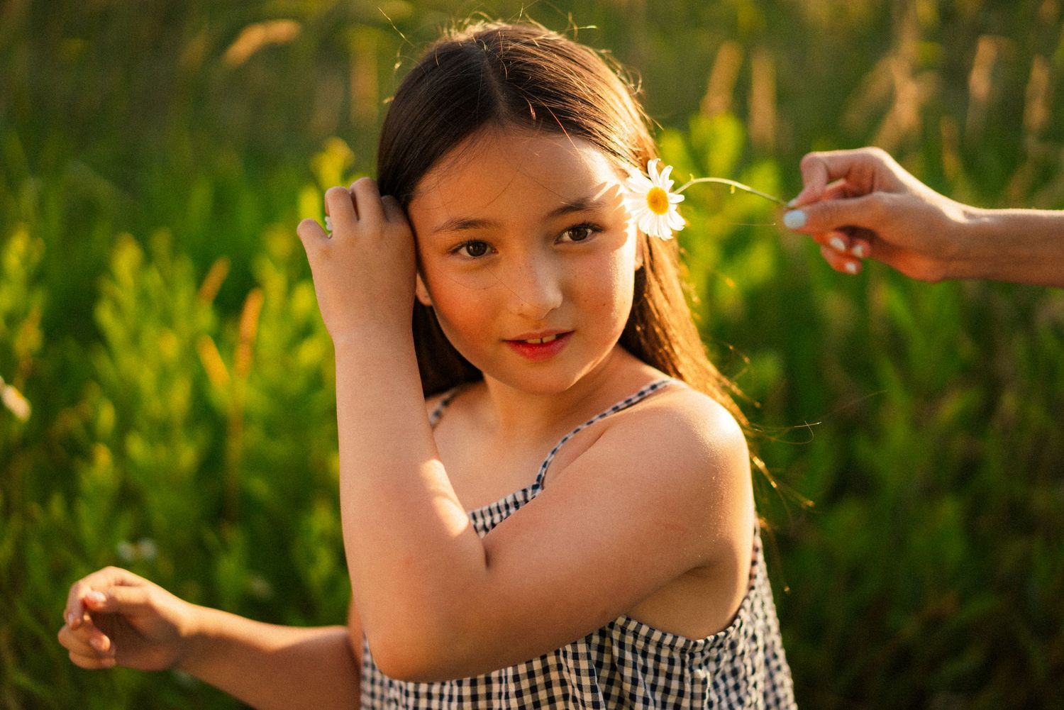 Summer portrait in field with gentle hand motion.