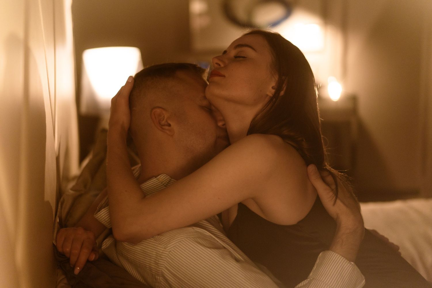 Romantic couple sharing an intimate moment in warm lighting.