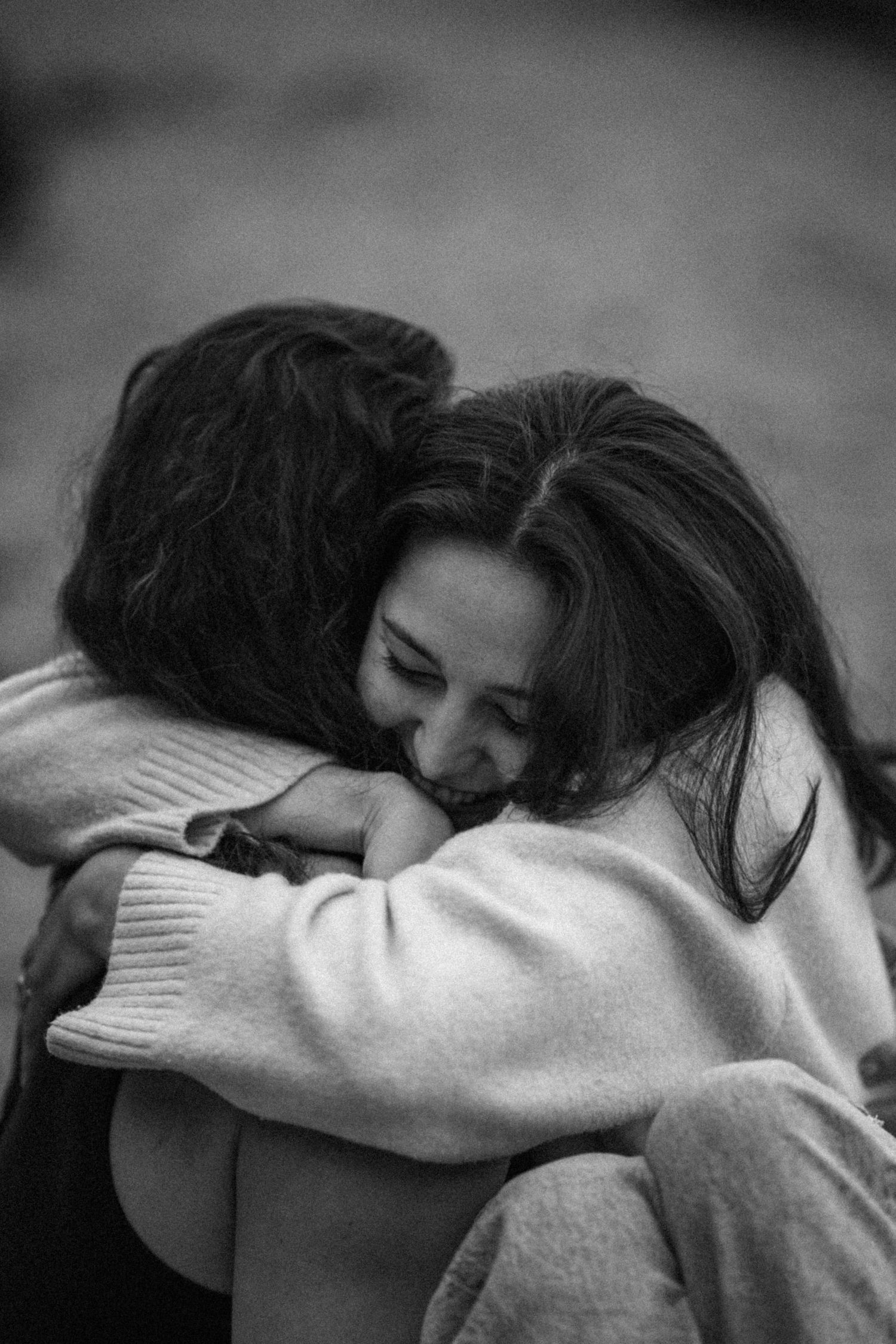 An intimate black and white photo series showing embracing figures.