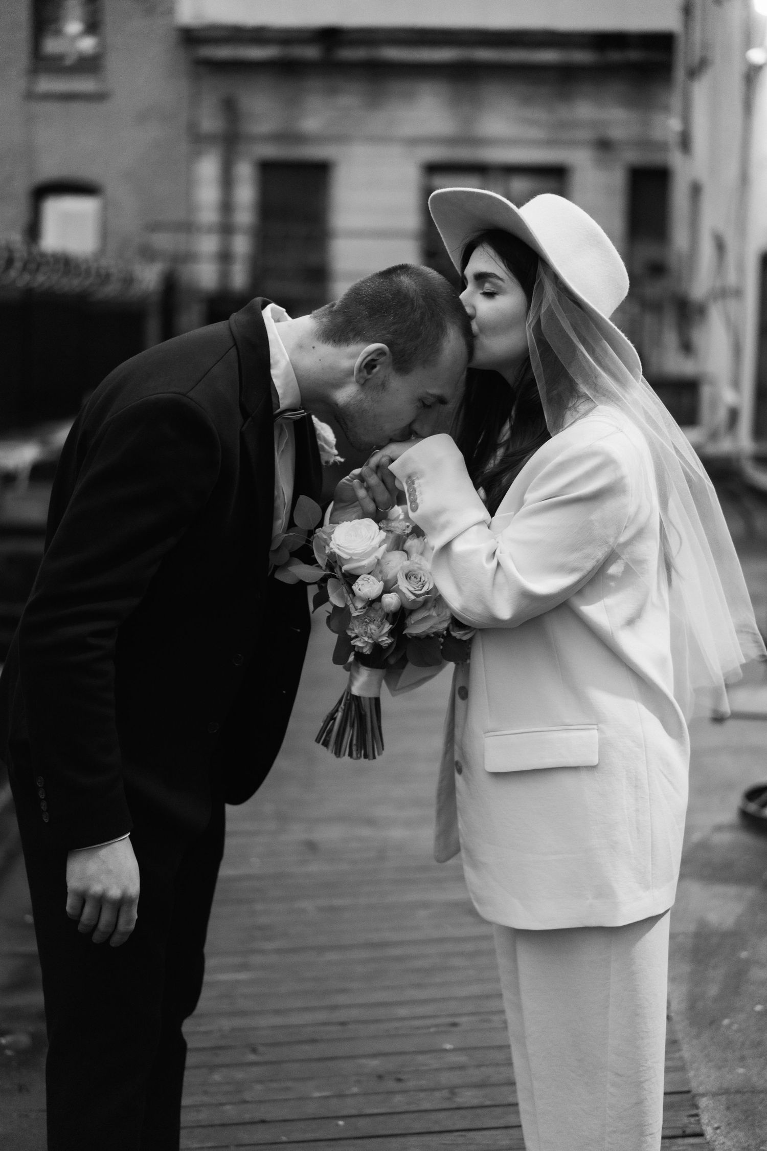 Black and white wedding photos showing intimate moments between the newlyweds.