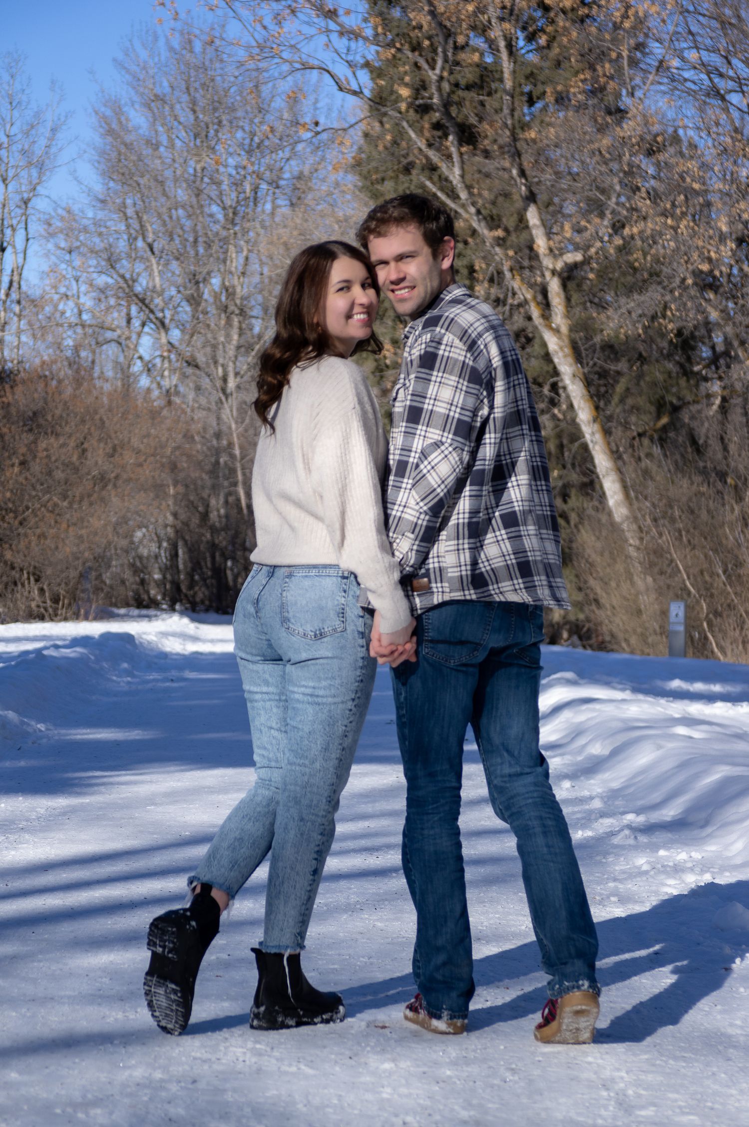 Central Alberta Real Estate Media David Spence Photography  newly engaged couple walking on a path in the winter Red Deer